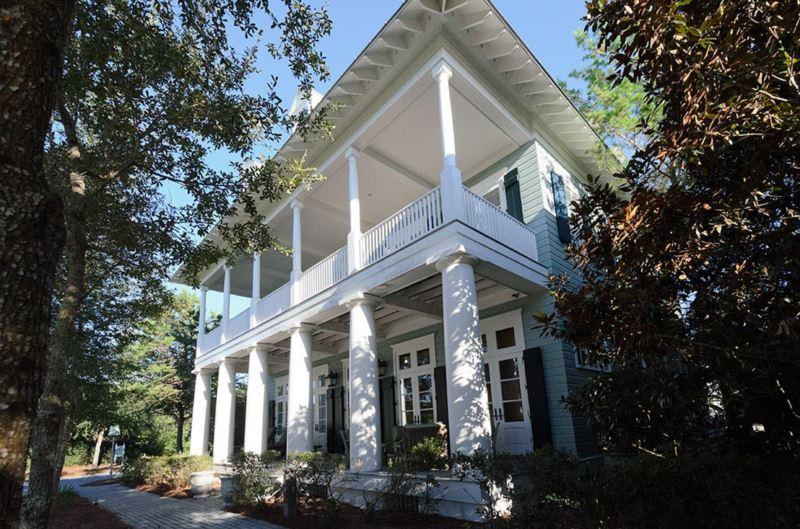 Garden District of New Orleans meets the best spot in Watercolor! This exquisitely built home is on Cerulean Park and steps from the beach and all the amenities. Designed by architect Eric Watson, the home features ionic style columns on the front porch that invite you into a spacious foyer with black slate tiles and an elegant staircase. Living room and dining room have 14' ceilings and old world crown molding with custom mahogany doors from France. The dark stained oak hardwood floors are in impeccable condition. A first floor master with his and hers closets AND bathrooms makes one floor living easy. A wainscoted library across from the living room is the perfect place to watch a movie or cozy up with a book.