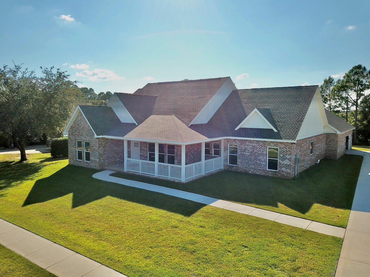 Welcome to 335 Club House Dr in the prestigious Windswept Estates golf community. This 2 year old custom built home is immaculate. With stunning curb appeal, and a manicured lawn, the home is extremely inviting. A spacious open floor plan with plenty of natural light, is great for entertaining, or just right for family time. The main areas of the home have LVP floor coverings, tile in the bathrooms, and carpeted bedrooms. The kitchen features all stainless appliances, with granite countertops. The master suite has a raised ceiling and a brick accent wall. Step into the master bath to find a separate soaker tub and shower. The home features a golf swing simulator room that has a separate mini split hvac. Step outside onto the expansive brick paver pool area to have amazing west facing sunset views.