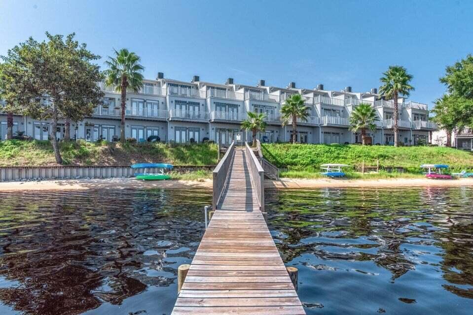 The ultimate water front living! This is the one you've been waiting for! Upscale 3 level townhome right on the East bay with boat slip and lift. Over 2035 sq/f  with 3 bedroom 3 full bath and a garage. The first floor consist of kitchen / living area with travertine floor and spectacular water view. 1 bedroom, bathroom and outdoor patio.The master suite with double french doors leading to balcony overlooking the bay  on  second story. Large master bathroom with walk-in-shower, double vanity and granite counter. Laundry area and additional bedroom with bathroom occupies the second floor.Third floor has a great room with wet bar, again double doors leading to this amazing oversize balcony for more of that breathtaking water view.Hidden Bay offers maintenance free living with community pool.