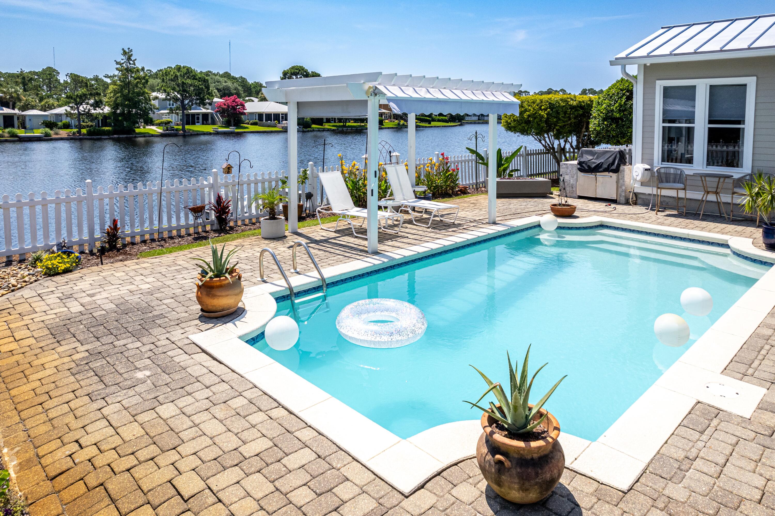 Located in the picturesque community of Crystal Lake, this freshly painted and updated lakefront retreat features a rare double car garage, oversized pavered driveway, and a private dock perfect for kayaking and fishing. Enjoy a refreshing pool with a new pump and an expansive outdoor living area complete with a newly added screened porch, pergola, and grilling station. Inside, the updated kitchen showcases quartz countertops, elevated appliances, custom pull-out shelving, and soft-close drawers. The spacious primary suite is on the first floor, offering lake views, a remodeled ensuite bath, and private access to the screened porch. A flexible second bedroom on the main level features its own ensuite bath, wet bar, and porch access, perfect for guests, home office or extra sitting room. Upstairs, find two guest bedrooms, a shared full bath, and a walk-in attic with freezer.
Additional highlights include: 2024 HVACs (both units), 2020 water heater. Multiple walk-in closets, Built-in overhead garage storage with an electric access ladder, and Two-way blinds throughout.
This home offers the perfect mix of functionality, comfort, and lakeside living. Sandestin Golf and Beach Resort features more than seven miles of beaches and pristine bay front, four championship golf courses, 15 world-class tennis courts, a 226-slip marina, a fitness center, spa and celebrity chef dining. Shop, dine and play at the charming pedestrian village, The Village of Baytowne Wharf and more. Inside the gates of the resort, residents enjoy a balanced lifestyle of high-class living, spanning the 2,400 acres from the beach to the bay. Everything within the gates of the resort is accessible by golf cart or bicycle. The entire resort is interconnected by miles of pedestrian, bike and golf cart paths that weave through groves of live oaks, meandering past natural lagoons, fountains, man-made lakes, and meticulously landscaped fairways.