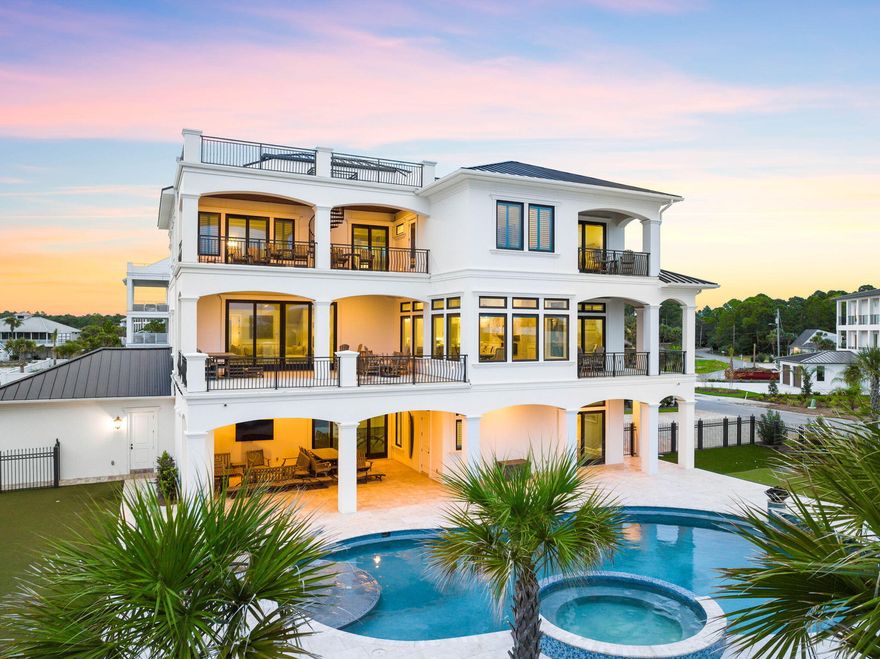 Welcome to 106 E Beach Drive, a coastal haven that redefines luxury living. This remarkable residence has a masterful vertical footprint with three stories of elegant design and a crowning fourth-floor rooftop deck yielding panoramic Gulf views while offering 6,480 square feet of pure opulence. Boasting 6 bedrooms and 8.5 full baths, this property is an embodiment of coastal chic design, nestled on a substantial 1/3 acre lot adjacent to the pristine Gulf of Mexico beaches. Heavily amenitized, notable features include a four car garage, massive resort style pool and adjoining spa, exemplary outdoor living, private movie theatre and in-home elevator. Prepare to be captivated by unobstructed 180-degree Gulf views that grace each level and culminate in the rooftop deck.