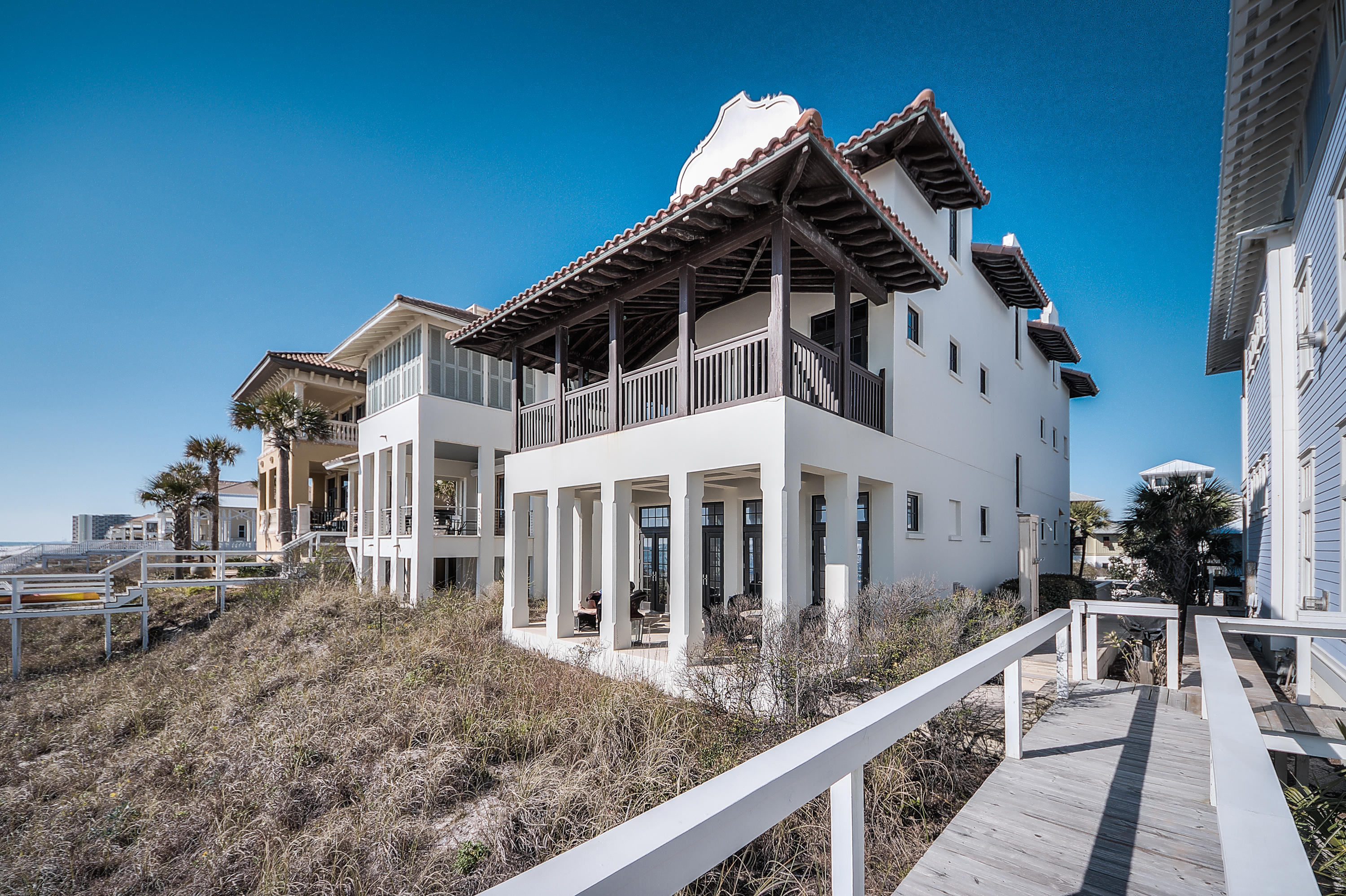 This fabulous Gulf front home, known as ''Seaduction'', was designed by renowned architect Gary Justiss and is truly stunning! Seaduction is a one of kind retreat in beautiful Carillon Beach with 4 bedrooms in the main house and an additional bedroom with luxurious living quarters in the guest house. Offering timeless design and construction with pecky cypress beams, hand wrought iron railings, stone flooring, spacious master suite, and breathtaking views of the sugar white sands and emerald green waters of the Gulf of Mexico. This home was designed as a place for many to gather together, while offering a peaceful retreat where everyone can find their own space to relax and unwind on island time.The first floor of the main house offers a completely open concept with sight lines