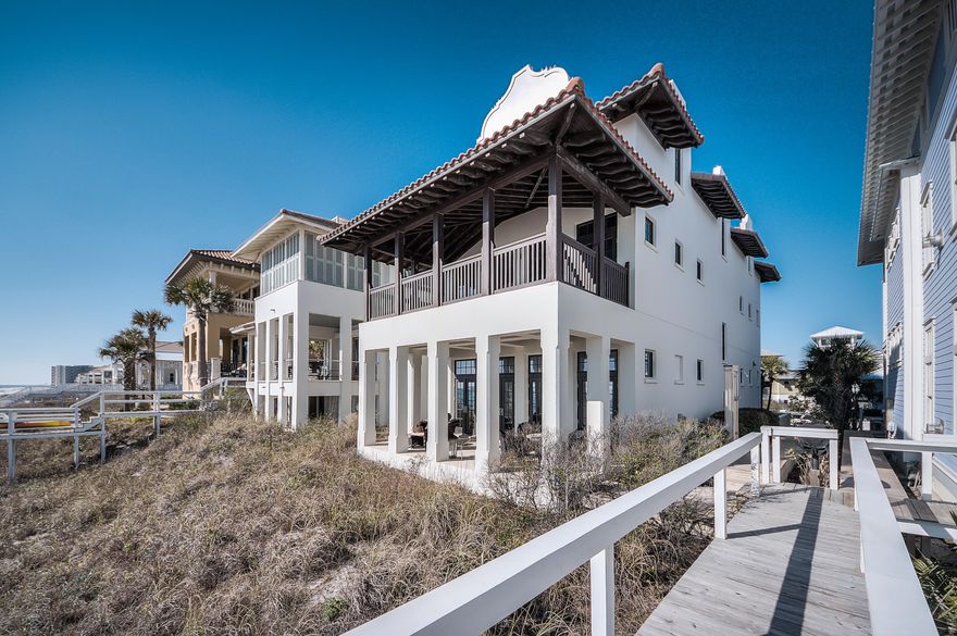 This fabulous Gulf front home, known as ''Seaduction'', was designed by renowned architect Gary Justiss and is truly stunning! Seaduction is a one of kind retreat in beautiful Carillon Beach with 4 bedrooms in the main house and an additional bedroom with luxurious living quarters in the guest house. Offering timeless design and construction with pecky cypress beams, hand wrought iron railings, stone flooring, spacious master suite, and breathtaking views of the sugar white sands and emerald green waters of the Gulf of Mexico. This home was designed as a place for many to gather together, while offering a peaceful retreat where everyone can find their own space to relax and unwind on island time.The first floor of the main house offers a completely open concept with sight lines out to the beach as soon as you enter. Here, you will find a beautiful and functional kitchen with Thermador, Wolf and Subzero appliances, as well as an elegant dining area, spacious living room with gas fireplace, and gulf front patio. You will also find a large wet bar and charming half bath tucked behind a beautifully detailed wood wall in the dining room.
The large master suite is located on the 2nd level, and offers its own private and spacious gulf front balcony, beautiful en suite bathroom, coffee bar, walk in closet and elegant pecky cypress beams sweeping throughout. You will also find a guest bedroom with its own full bath and one of three laundry rooms on this level. 
The third level of Seaduction offers 2 additional bedrooms, each with a private balcony, and a dedicated full guest bathroom. The stunning feature of the 3rd level is a very spacious multi functional room with breathtaking views of the gulf.
Seaduction's guest house was no afterthought, as the exquisite design and attention to detail makes these additional living quarters fully functional on their own. Large living room with fully equipped kitchen, full bath and additional bunks built into the wall are located on the main level of the guest house, while the downstairs includes a very spacious bedroom, full bath and fabulous sleeper porch. 
Additional features include elevator from ground to main and 2nd floor, 2 attached garage style golf cart bays, outdoor shower, large outdoor storage area, and fully integrated audio, video and security system. Seaduction is turn key and has never been used as a rental. Tastefully furnished and decorated by Sally Logan Interiors and Mayo Design center in Atlanta. With no detail overlooked this is truly a stunning place to call home.
Enjoy everything Carillon Beach community has to offer, such as tennis and basketball courts, 3 community pools, children's park, village green and the downtown Carillon area with live music, shops and eateries. Or relax and enjoy the serenity of kayaking or fishing in Lake Carillon, the secluded 13 acre lake inside the gates. Carillon is a pedestrian and golf cart friendly community, allowing you to park the car and leave it while you enjoy everything it has to offer.