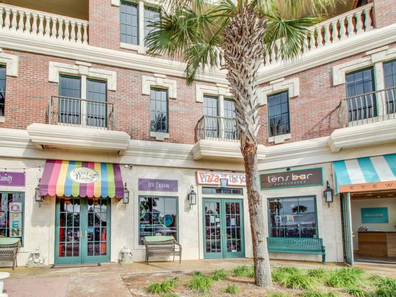 2nd floor studio unit directly above shops and restaurants of Village of South Walton. Corner unit with large windows on 2 sides. Fully furnished with great rental income and reviews. Easy parking and steps away from 2 heated community pools and hot tub. Includes complementary shuttle/tram service to private beach access across the street. Kitchenette features stainless appliances and granite countertop. Travertine tiled floors throughout. Paths for walking/biking next door to Alys, Seacrest & Rosemary Beaches.