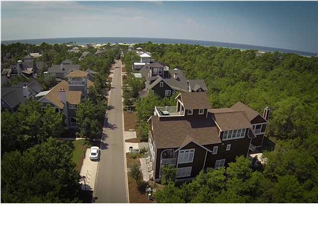 This custom designed home in WaterSound Beach sits on a fantastic expansive lot that fronts the manicured Puttering Park and backs to the private Deer Lake State conservation area, so privacy abounds. In harmony with its surroundings, this nantucket inspired, Thurber designed home, boasts over 6,400 square feet under roof, 4,300 heated and cooled. You will be thoroughly impressed at the level of craftsmanship and creativity found in every detail of this magnificent home. Only the finest materials have been used in the creation of this property, such as wide plank red oak floors, carrara marble, imported glass tile, pecky cypress custom doors and cabinets, tongue and groove walls, cedar shakes, and so much more. Enjoy the benefits of this inverted floor plan with four guest bedrooms on the