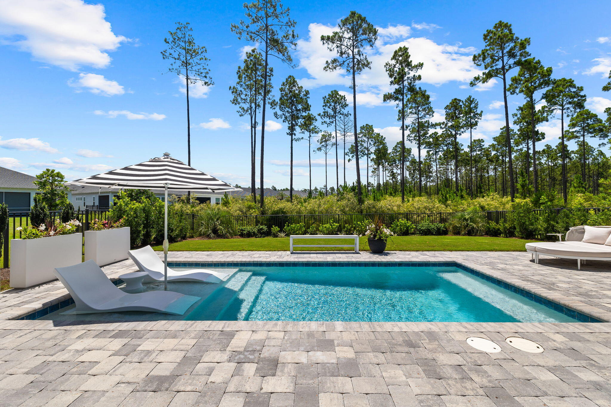 Best priced home with a pool! Move-in ready! No punch list, no delays, and no warranty work to chase down. A retreat that offers an instant coastal lifestyle. This thoughtfully designed floor plan can function as a 3 bedroom or a 2 bedroom with a versatile 11x12 flex room for a home office, den, or guest room. Nestled in the sought-after gated community of Naturewalk at Watersound Origins, this stunning home offers the perfect blend of modern coastal elegance and serene natural surroundings. This Highland one level floor plan features bright interiors and spacious interiors.The backyard is a true oasis, backing up to a protected wooded preserve, it provides a tranquil and private setting. Thoughtfully designed landscaping enhances the beauty of the space, while the pool's sun shelf with in-water loungers offers a relaxing retreat. Enjoy the shade and cool breezes in the late afternoons over the Florida pines from your screened lanai.
Inside, the gourmet kitchen boasts quartz countertops, Caf?? appliances, a 36" gas cooktop with a Monogram range hood, and a walk-in pantry. Numerous architectural details such as V-Groove trim in the foyer and dining area add a modern touch, while board and batten accents elevate both bedrooms and bathrooms. Additional upgrades include Bermuda shutters, designer window treatments, and upgraded selections.
Naturewalk at Watersound Origins offers an unparalleled lifestyle with resort-style amenities. Residents enjoy a resort style amenities center complete with a large pool, hot tub, fire pit, bar area with TV, pickleball and tennis courts, and a state-of-the-art fitness center.
Additionally, the community provides access to the Origins event lawn, unlimited golf, and kayaking on Lake Powell.
Ideally located on the east end of the renowned 30A corridor, this property is just minutes from the pristine beaches of Alys Beach and Rosemary Beach, as well as world-class dining, boutique shopping, and endless outdoor activities.
This home offers not just luxury and style, but the ultimate convenience: move in ready and the ability to enjoy the pool from day one! Skip the stress, cost, and construction delays. Instead, have your own private oasis, perfect for relaxing and entertaining. Your next chapter can begin at the beach today!