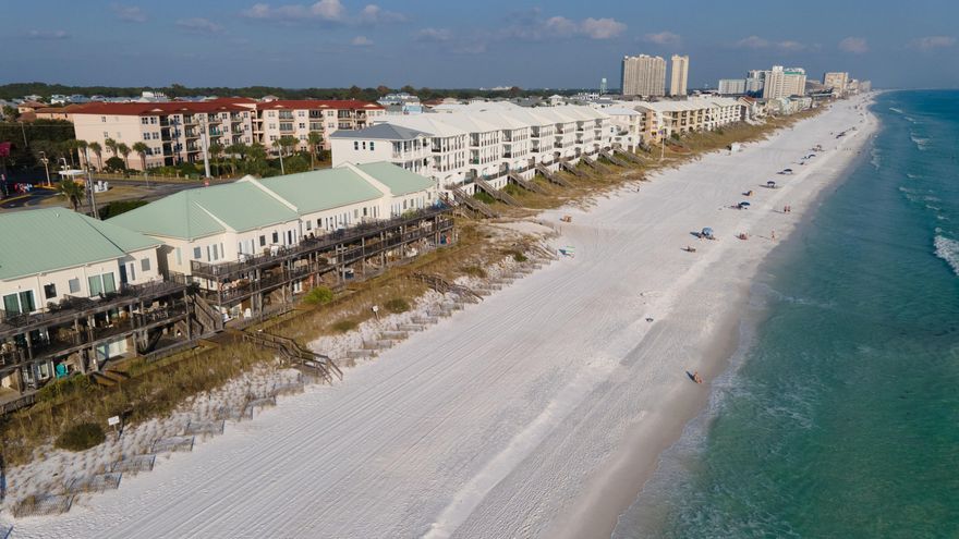 Not since 1994 did you have an opportunity to own this charming renovated townhouse perched directly on the beach.Best of all this gem includes deeded beach property to the high water line, a rare option! This fully furnished 3 level, 3 bedroom, 3.5 bath townhome has 3 oversized decks for taking in the sunset or sunrise over the Gulf. HOA fees are minimal. Two assigned parking spots are directly in front of the entry door.The beach level apartment has its own door to the beach. Tile and hardwood floors offer easy cleaning. Climb the stairs to the 3rd floor to find guest bedroom and master bedroom with dynamic views and private deck.The million dollar views cannot be topped! Square footage submitted by Seller.