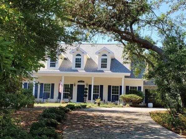 Classic Southern architecture and charm, breezy gracious porches in both the front and back, and a private yard that offers a beautiful pool in an extremely peaceful setting all within easy walking distance to the private gated walkover to the Gulf of Mexico. Four bedrooms, 2 -1/2 baths, an office, large laundry room and an open concept living area are complimented by numerous and large windows that invite the outside in. The two car garage has floor to ceiling peg board along the wall for hanging items as well as a large storage closet.The home has 2799 square feet of living space and the beautiful lot is over a half acre in the desirable Seabreeze neighborhood right off scenic 30a.