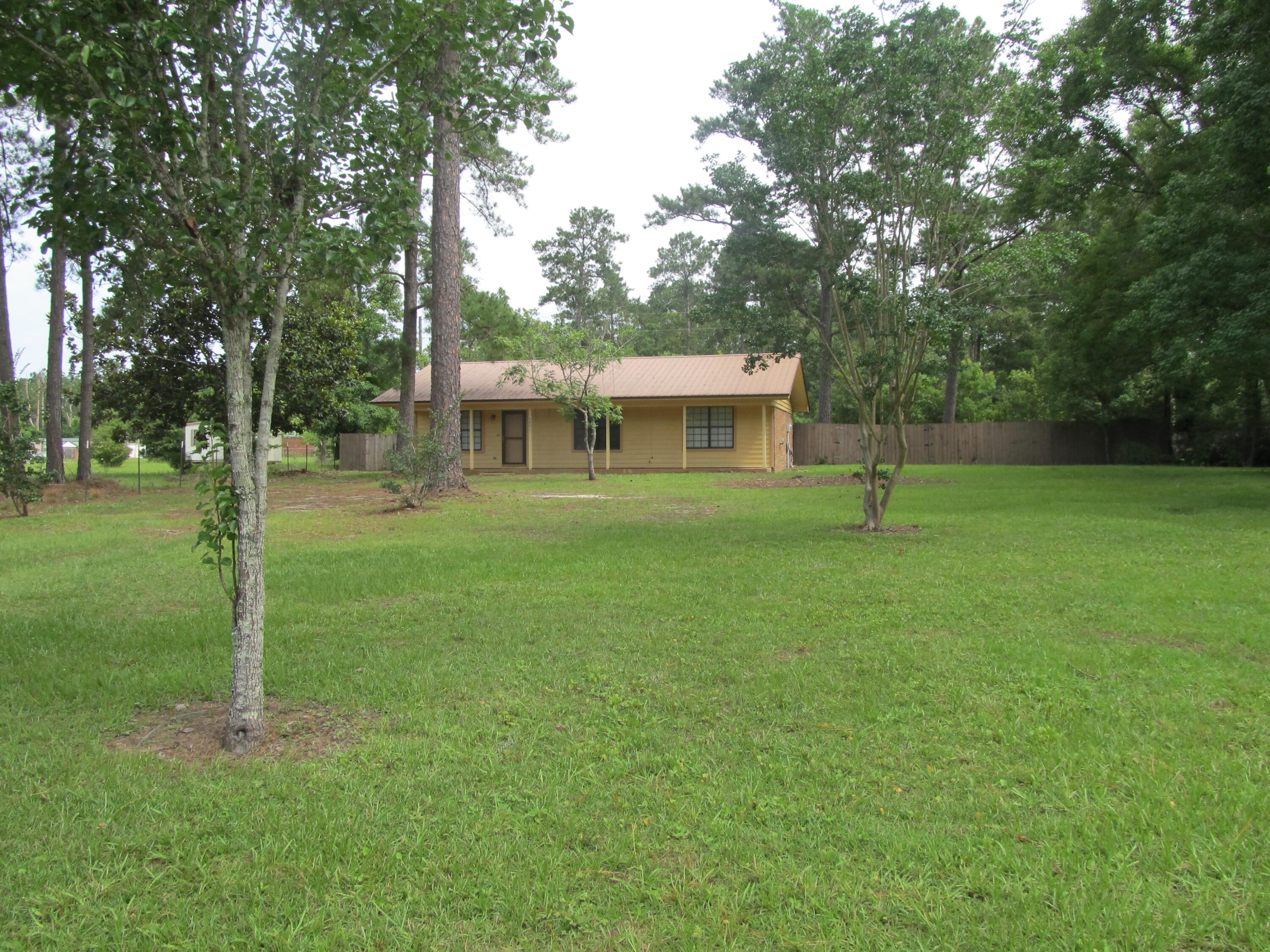 Great home located just South of DeFuniak Springs, This 2 bedroom/2 bath home features open floor plan, large master bedroom with walk-in closet and spacious master bath. Kitchen features island storage and large dining space for family to gather. Large closet in guest bath give added storage. The 10' x 18.5' patio and fire pit are perfect for outdoor enjoyment with fencing that provides additional privacy. Back yard is large enough to build pool if desired. Home was originally built as 3 bedroom/2 bath but remodeled for large master suite. Property is convenient to everything - Shopping Center 1.5 miles, Historic District of DeFuniak Springs 5 miles, Choctawhatchee Bay 19 miles, and South Walton beaches 27 miles. Schedule your showing today.