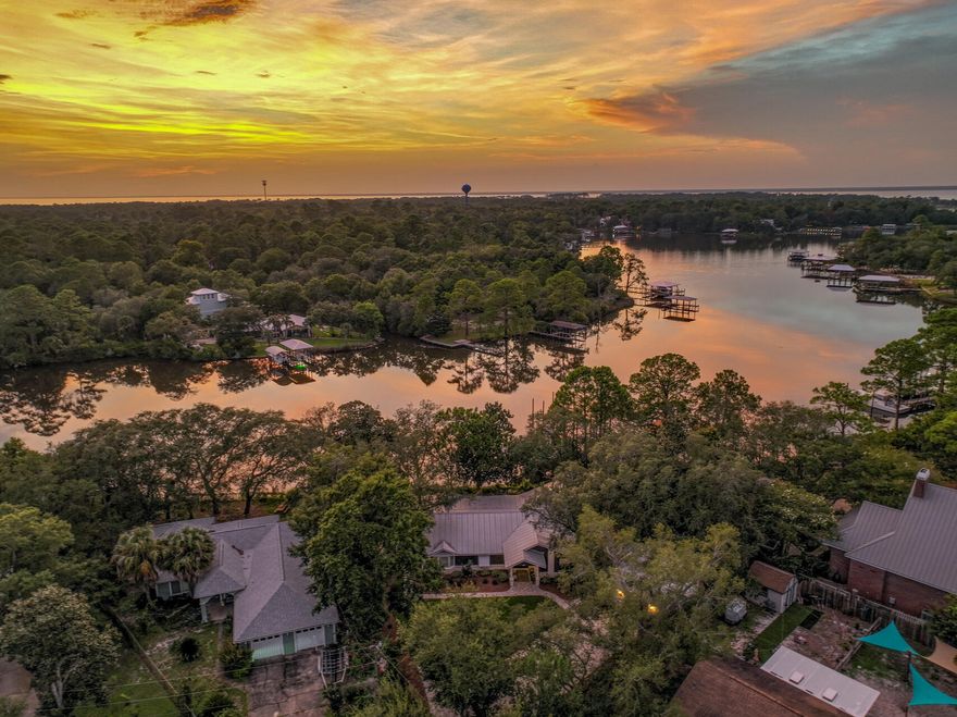 Welcome to 58 Initial Lane, a beautifully remodeled waterfront gem that combines luxurious living with serene natural beauty. This unique home features 4 bedrooms and 3 bathrooms all on one level, designed with meticulous attention to detail for ultimate ease of living. The interior showcases original hardwood floors and upscale finishes throughout, with a completely remodeled kitchen and bathrooms that add a touch of modern elegance. Step outside to discover your private dock and boat lift, set on a deep-water bayou with direct access to Choctawhatchee Bay. Ideal for fishing enthusiasts, the property offers breathtaking sunsets and a tranquil setting in a quiet neighborhood with no HOA restrictions. Every detail of this home has been thoughtfully designed to enhance comfort and style. The standout feature is the waterfront primary bedroom, which includes a private, secluded sitting room perfect for relaxation. The spa-like master bathroom is a highlight, featuring an original clawfoot tub that adds a touch of timeless elegance. Don't miss this rare opportunity to own a piece of waterfront paradise. Schedule your private showing today!
