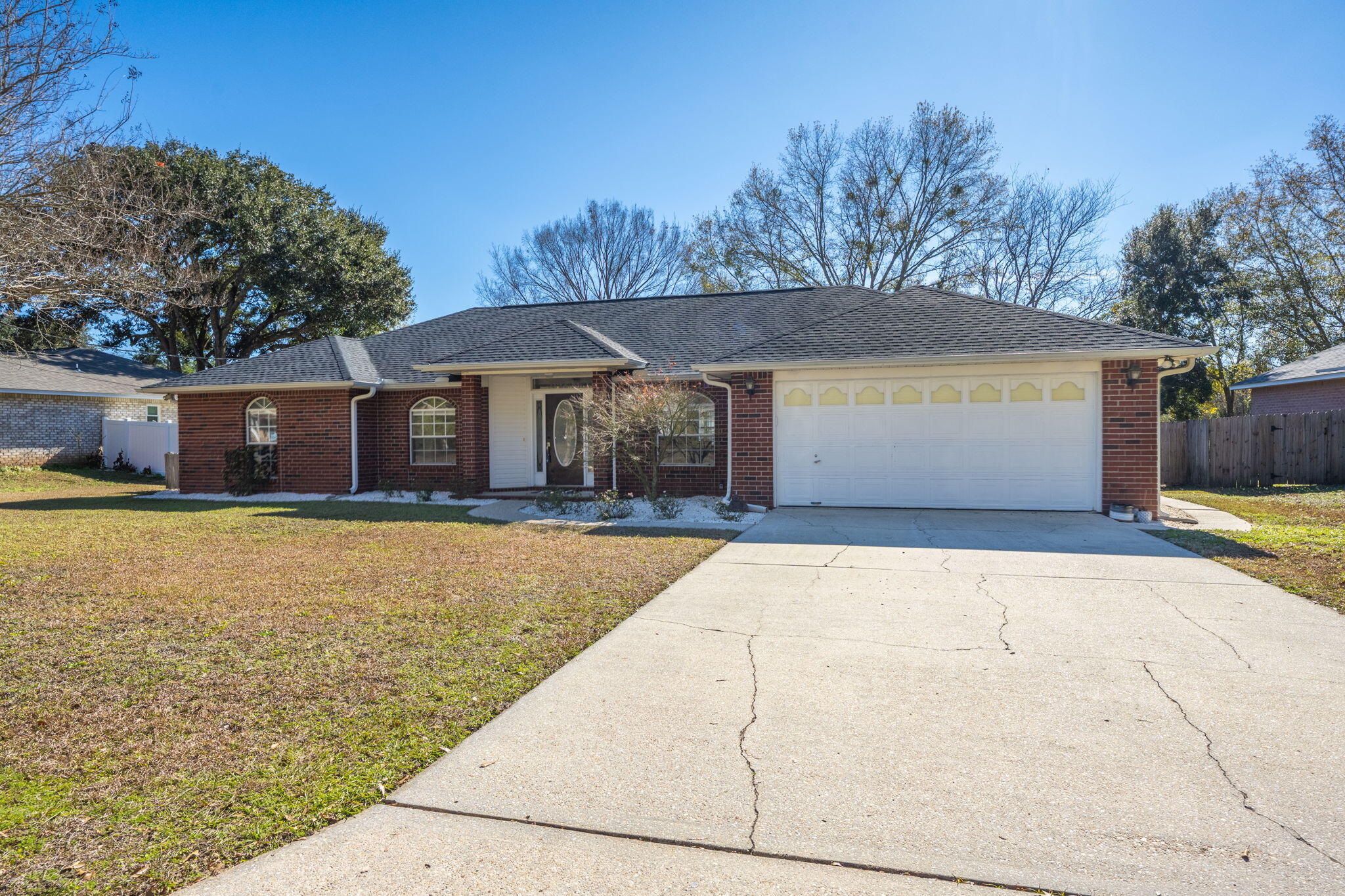 Welcome to this charming 3-bedroom, 2-bathroom brick pool home located in the heart of Pace, just off Woodbine. This beautifully updated property offers a perfect blend of modern features and timeless comfort, making it an ideal place to call home. This home features a 2022 roof, new LVP flooring, and fresh paint throughout. Step inside to discover an inviting open concept floor plan that seamlessly connects the living, dining, and kitchen areas. The updated kitchen is a true highlight, featuring butcher block countertops, a brand-new farmhouse sink, and stylish new cabinet hardware. The kitchen flows effortlessly into the dining area and spacious living room, where cathedral ceilings, built-in shelves, and a cozy wood-burning fireplace provide a warm and welcoming space for family gath erings or entertaining guests. The sunroom at the rear of the house leads out to a fully fenced backyard, a true oasis for outdoor living. Featuring an inground saltwater pool complete with a new pump, saltwater filter, and saltwater cell, making maintenance a breeze. The backyard also includes a spacious yard and a shed for extra storage, providing ample space for all your outdoor activities and needs. The split primary bedroom is a private retreat, boasting a generous layout with a tray ceiling that adds a touch of elegance. The ensuite bathroom has been thoughtfully updated with a new double vanity topped with quartz countertops, a new shower, new toilet, as well as a garden tub and a walk-in closet, offering both luxury and convenience. On the other side of the home, you'll find two additional bedrooms, each featuring new trim, and a fully updated bathroom with a new vanity, shower, and toilet. This delightful home offers everything you need for comfortable living and entertaining, all in a convenient location in Pace. Don't miss the opportunity to make this beautiful property your own!