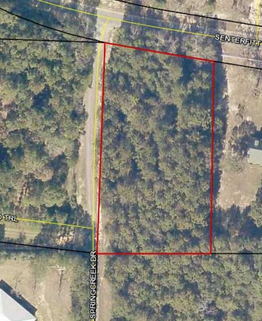 Large, Corner lot on paved road North of Crestview. The lot is wooded and gently sloping. Great place to build a new home!
