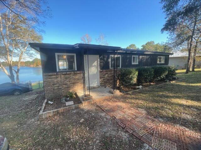 Renovated waterfront home located on Juniper Lake! New updates include luxury vinyl plank flooring and sub flooring, new interior paint, new toilets, new outside dock, new security system and new HVAC unit and new hot water heater. Clean termite inspection and bond. Inside you'll find two spacious bedrooms with walk in closets, and open living/dining area that flows from the kitchen. Get some fresh air in your large screened in porch overlooking the lake, or venture outside onto your brand new dock and watch the sunset! This home would make an incredible family getaway, rental or family home.