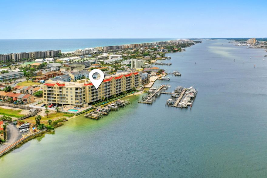 Enjoy breathtaking views of the Gulf, Intracoastal Waterway, and Santa Rosa Sound from this fully furnished 2-bedroom, 2-bath condo. This spacious unit features tile and carpet throughout and comes fully furnished. The open layout includes a convenient laundry area completed with full sized washer and dryer. Both bedrooms offer ensuite bathrooms for added privacy. The main suite features a relaxing tub and separate tiled shower, while the second bedroom also includes a tiled shower.This condo comes with a deeded boat slip--perfect for days out on the water.