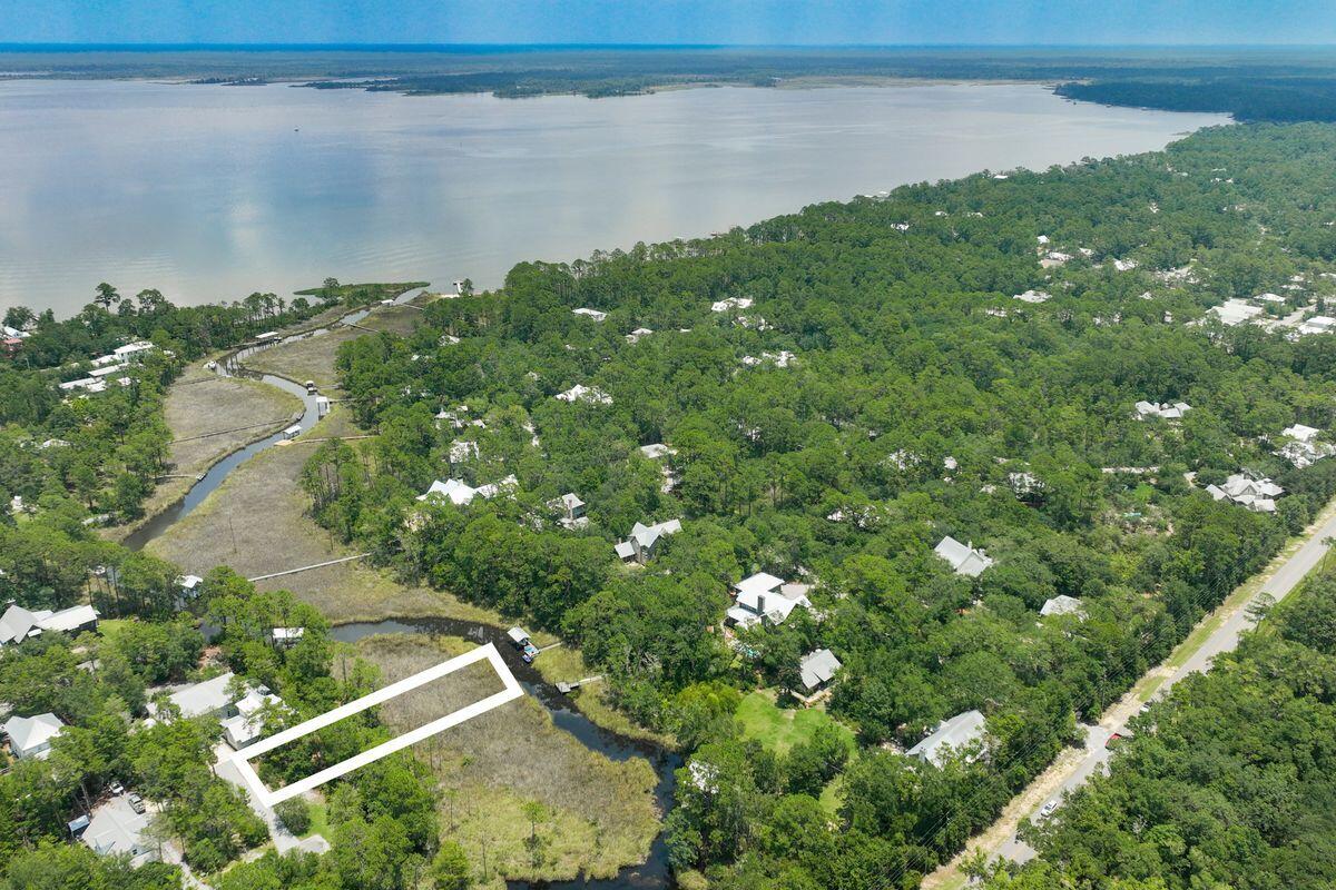 Discover a great opportunity in Point Washington. This vacant lot, nestled in the peaceful area of Magnolia Beach, offers a unique selling point - it backs up to a canal that leads to the bayou. Imagine enjoying short rides on the canal and embracing the tranquility of waterfront living. It sits near plenty of shopping and dining opportunities and is just a short drive to the world-renowned South Walton beaches. The renderings are a sample of what could be built on this amazing lot.