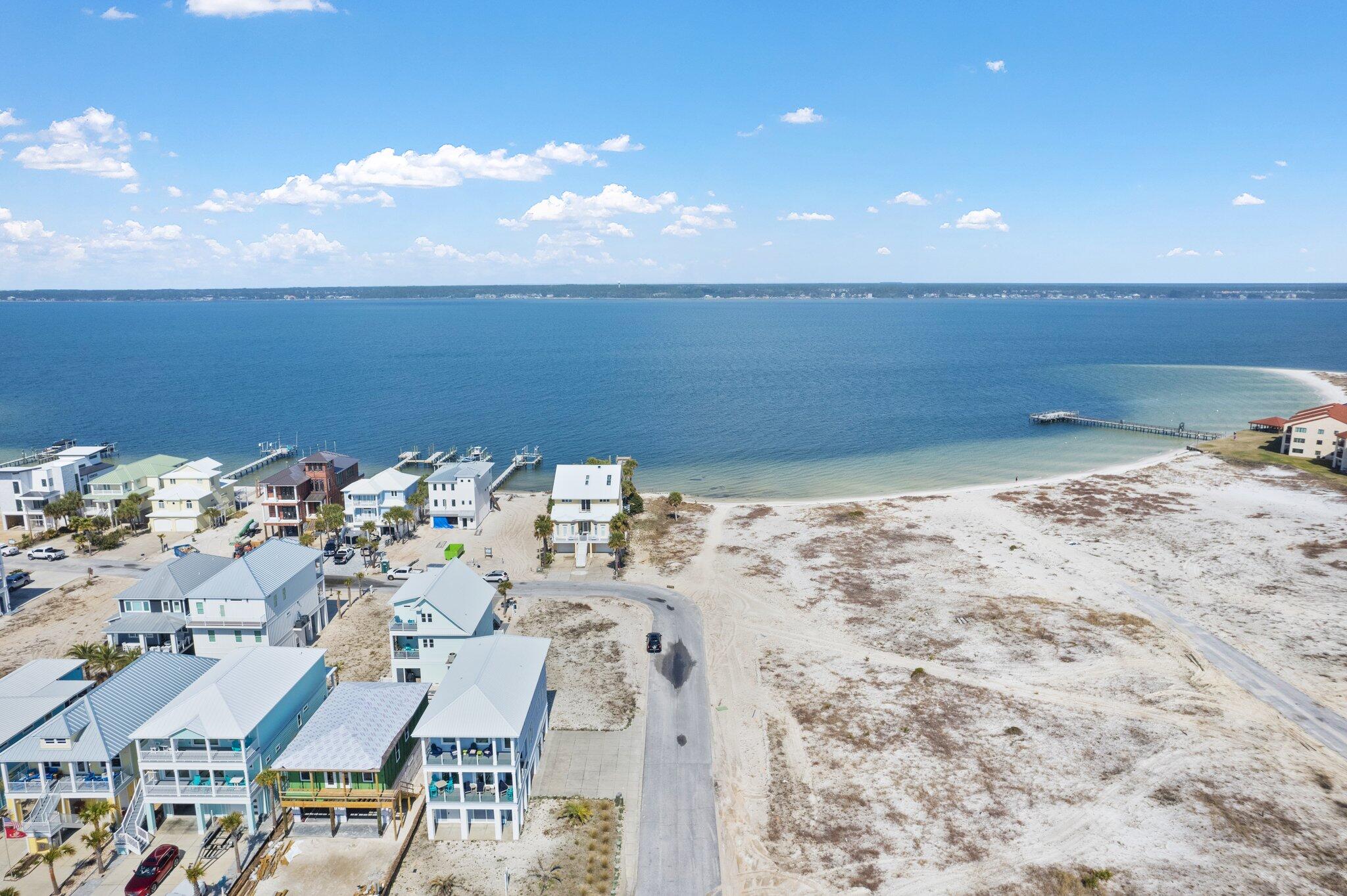 ***DEEP WATER LOT*** LOCATED AT THE END OF THE STREET AND A SHORT WALK (OR GOLF CART RIDE) TO THE GULF BEACHES (ACROSS FROM THE PUBLIC BEACH ACCESS) Dream Waterfront Oasis Awaits on the Santa Rosa Sound! Own a piece of paradise with this stunning waterfront lot directly on the Santa Rosa Sound on the island at sought-after Navarre Beach. This pristine .22-acre property boasts 62 feet of waterfront with a white sandy beach, offering unparalleled access to the tranquility and adventure of the Sound. Boating enthusiasts rejoice! Deep water access allows you to easily dock your boat right at your own property, ready for exciting fishing trips or leisurely cruises. Relax on your private beach, soaking up the Florida sunshine and listening to the gentle sound of waves lapping the shore on a sun-drenched day. Imagine kayaking, paddleboarding, and fishing right on the calm waters behind your future home or investment property. This prime location at the end of Grand Navarre Blvd offers tranquility and privacy, while still being within easy reach of all the excitement. Just a short drive down to the longest pier on the Gulf of Mexico where you can spot sea turtles, dolphins, or bring your fishing rod. Take a jog or your bike and enjoy the scenery along the National Seashore and Opal Beach, giving you breath-taking views with water and white sandy beaches on both sides of the road in an unspoiled natural paradise. Come see it today!