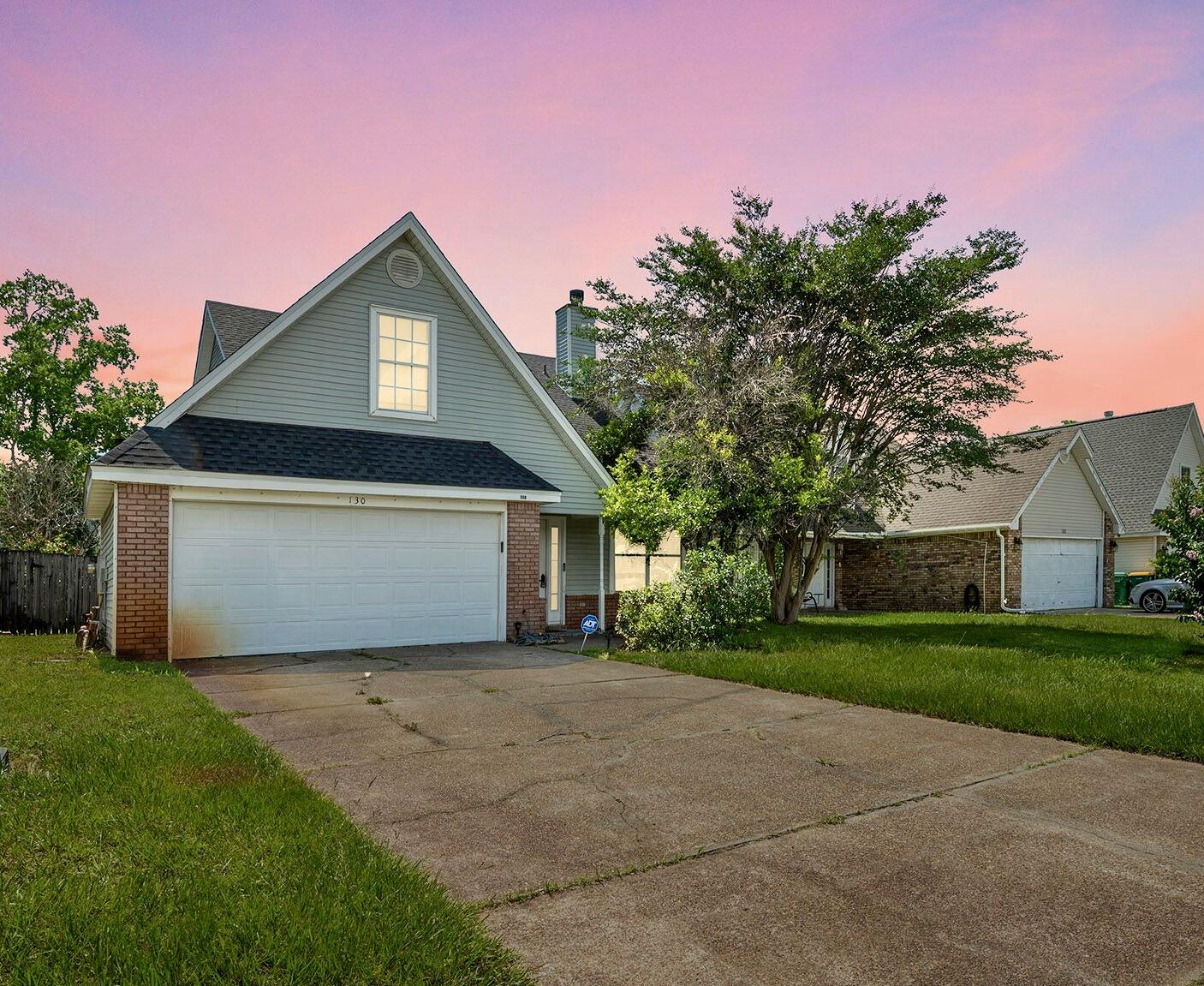 Check out this roomy home featuring a 2021 roof, 2024 HVAC, and stunning hardwood and tile floors throughout. The great room offers a vaulted ceiling, ceiling fan, and a cozy fireplace adorned with a wood mantle and tile facia. A spacious den, complete with its own bar, provides a relaxing view of the backyard. The expansive eat-in kitchen is filled with ample cabinetry, perfect for all your storage needs.Upstairs you'll find 3 bedrooms and a full bath. There is an upstairs loft that overlooks the living room which is perfect for an office, study nook, or lounge.