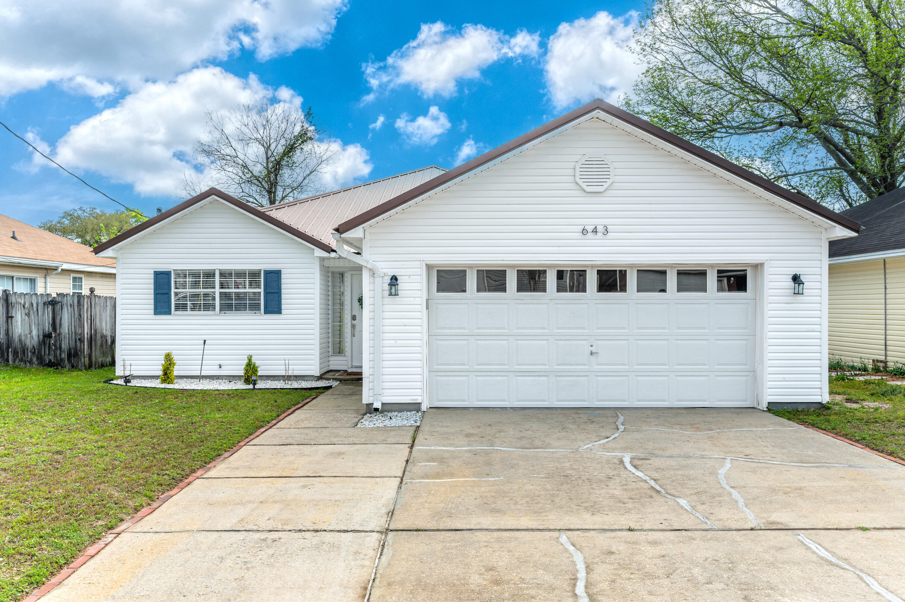 Welcome to 643 Jerrells Ave, an inviting single-family residence nestled in the heart of Fort Walton Beach, FL. This charming home offers 1,396 square feet of thoughtfully designed living space, featuring three spacious bedrooms, two bathrooms, and a two car garage. Metal Roof 2020, HVAC & Water Heater 2021. **Assumable 4.125% VA interest Rate**As you step inside, you'll be greeted by a warm and welcoming atmosphere, perfect for relaxation and entertainment. The open-concept living area flows seamlessly into the dining area and the well-equipped kitchen, providing ample space for culinary adventures and gatherings. The recently updated kitchen features an undermount stainless sink, quartz countertops and stainless steel appliances. The living area offers tray ceilings and LVP flooring. Just off the living are french doors leading you to the covered back porch area, which is perfect from relaxing or grilling.
The backyard is completely fenced in offering endless possibilities for outdoor activities, gardening, or simply enjoying the Florida sunshine.
Back inside, the primary bedroom is a peaceful retreat, complete with a walk-in closet and an en-suite bathroom for added convenience and privacy. Two additional bedrooms offer versatility for guests, a home office, or creative spaces. The second bathroom is just off the hallway and is easily accessible from the common areas.
The location of this home provides easy access to local amenities, recreational opportunities, and the vibrant community of Fort Walton Beach. This delightful home at 643 Jerrells Ave is a wonderful opportunity for those seeking comfort and convenience in a desirable location. Don't miss out on the chance to make this property your own. Schedule a viewing today and experience all that this home has to offer!
