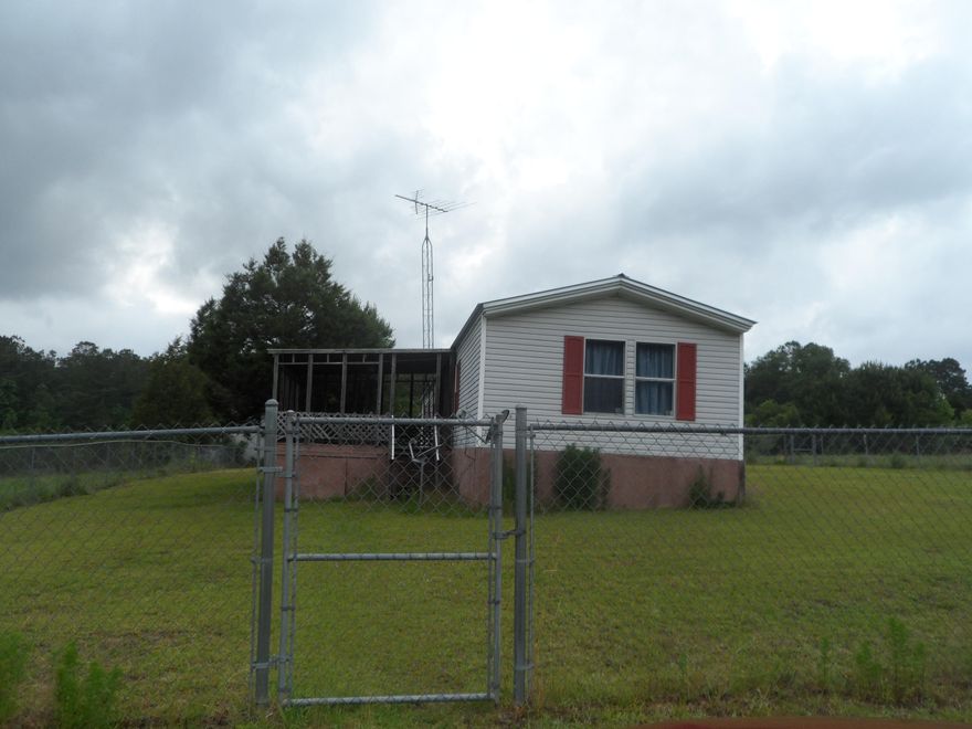 Fish to your hearts content in the large stocked 2 acre approx fish Pond. This pond is creek feed and always has water. Sit on the front porch and enjoy the water. Live your dream in this 1996, 16x80 single wide Fleetwood mobile home with added 128 Sq Ft storage room, front and back porches of approx 407 s. ft. It is very well maintained and has no issues noted. It is 10 acres of peace and quite in your own little piece of heaven. There is a fence around the house. It has thick beautiful grass in yard. There is field fencing around the entire 10 acres. A Dream place for the man or woman of the house to enjoy the 1536 Sq ft Workshop, metal building with garage door on side. It has electric and a concrete floor with a attached shed.This place has it all. Make your appointment to see now