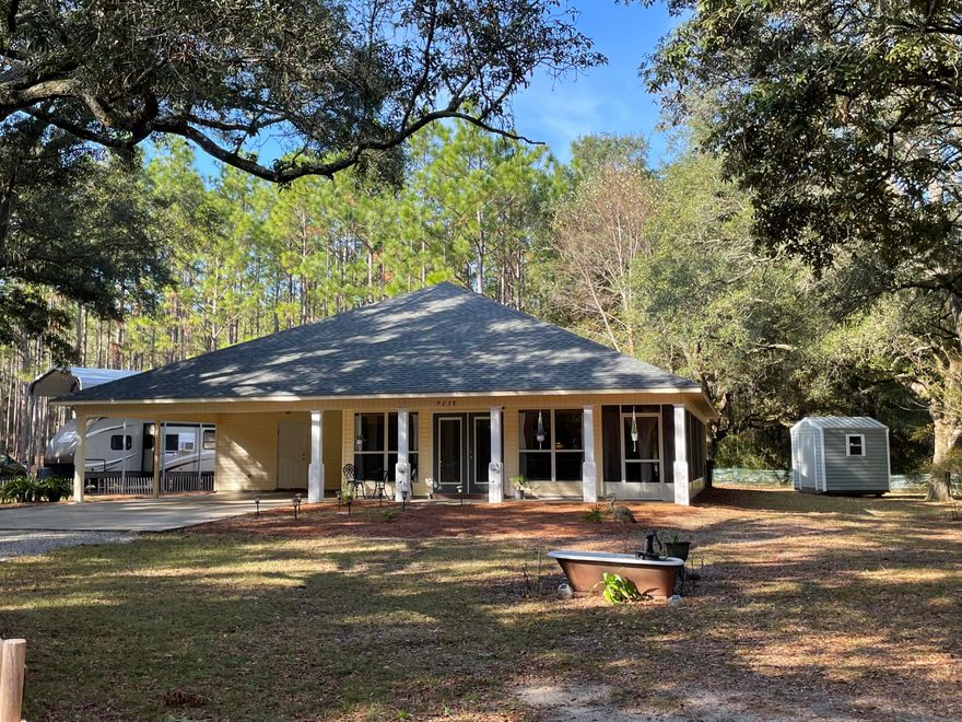 Get the charm of living in the country on 2.27 acres with a beautiful 2 bedroom 2 bath home. 2 minutes to 1-10 and a 15 minute drive to the beach. EZ drive to military bases and shopping. New HVAC 6/22, New roof with lifetime dimensional shingles 1/22, new 8x8 shed 6/20, New RV/Boat metal carport 2022 (with wind rated 160 miles per hour) screened porch, ceiling fans, vaulted ceiling, bamboo floors, handicap provisions including extra wide doors, large master bedroom and bath, septic tank inspected 3 years ago, Property lined with large beautiful oak trees and pine trees. Underground utilities.  A Must See!!!!