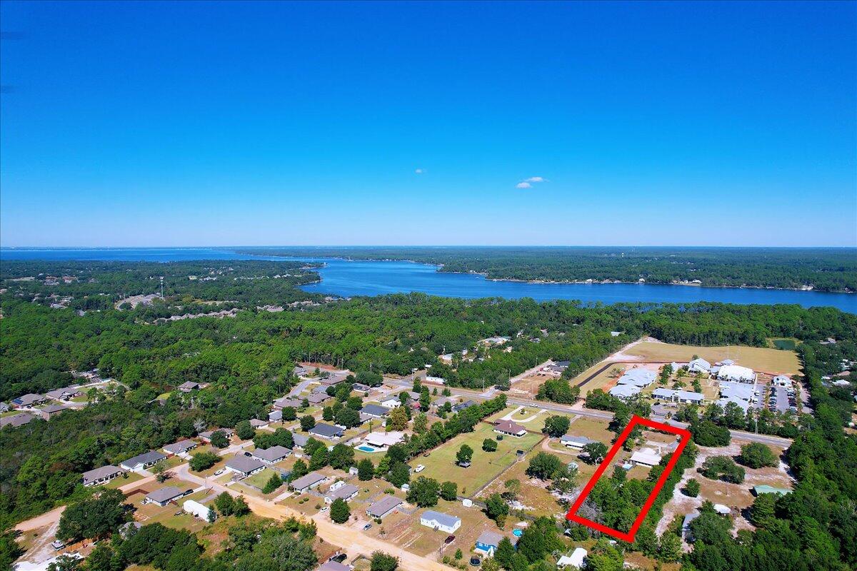 BACK ON THE MARKET! NO FAULT OF SELLERS! MOTIVATED..NO HOA!!1.18 ACRES in Navarre!! Spend your days relaxing by the Pool, or enjoying the warm waters in the hot tub at night. METAL ROOF 2016/HVAC 2020/WH 2020 This spacious 3 bedroom 2.5 bath ranch style home has all the amenities one would desire indoors or outdoors...including an (approx) 900sqft WORKSHOP with power! Absolutely NO Carpet throughout!! Ceramic tile throughout the living room, spare bedroom, and kitchen. LVP flooring in hallway, second bedroom, and primary bedroom. So much room to spread out...bring your land and water vehicles, or even your RV. Not in a recorded subdivision. All the appliances stay including washer/dryer! Call listing agent for details or further information. Notice for ALL Showings...See agent noteS
