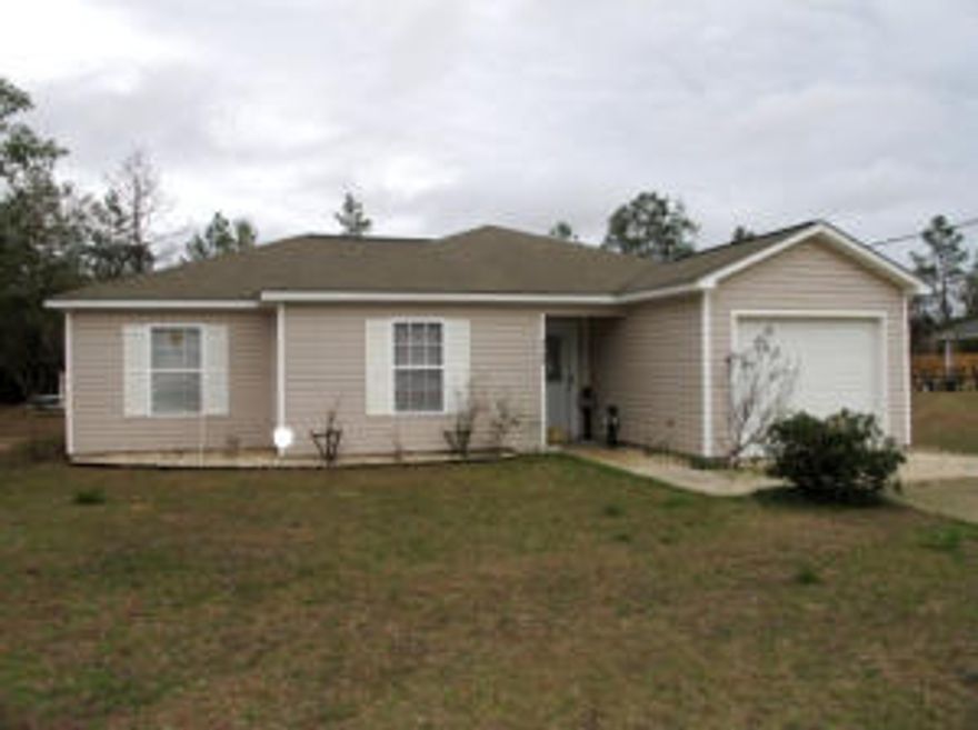Crestview Mossy Head area home on huge lot with wood laminate and tile floors and modern colors. There is a wall of movable storage in the garage. The half-acre lot is flat and cleared. There is plenty of room to set up your shop or play with pets. Wired for security system. What a find within easy commute to Eglin Air Force Base, 35 minutes to the Destin beaches on the new Mid-Bay bypass, and nearby Blackstone Golf Course!