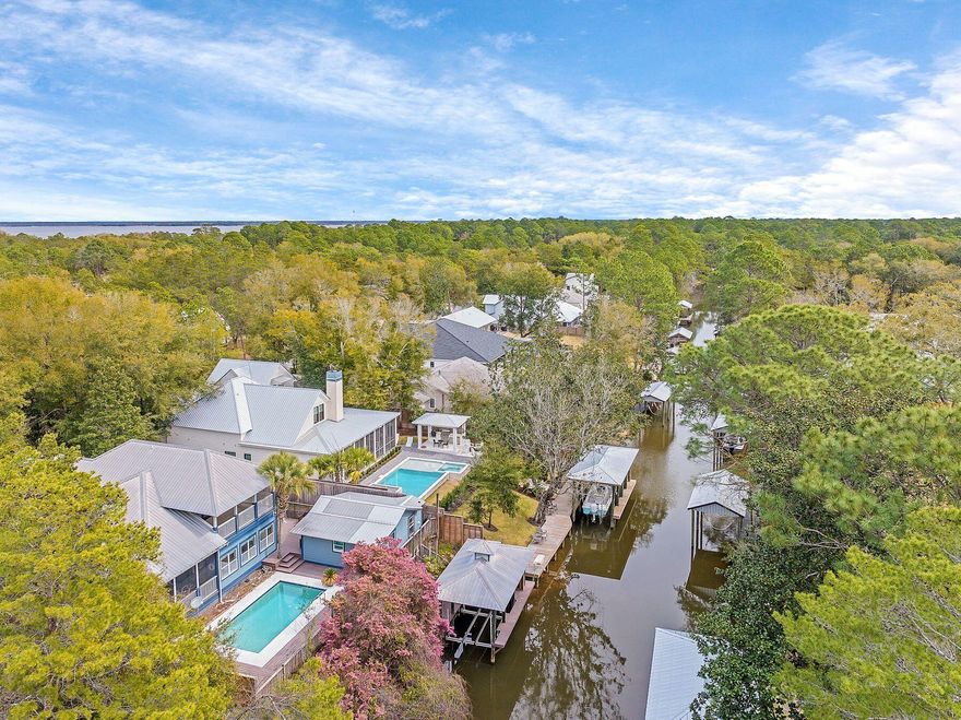 ***Under Contract - Accepting Back-Up Offers*** Nestled in picturesque neighborhood of Point Washington, this canal-front home offers 75 feet of water frontage with a covered boat lift, a guest cottage and a private pool offering endless opportunities for outdoor activities with direct access to the Choctawhatchee Bay. A paver circle driveway provides a welcoming entry to the primary home with three bedrooms and two and one half bathrooms, a spacious floor plan with vaulted ceilings, two living areas and large screened porches.