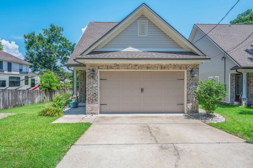 This beautiful four-bedroom, two-and-a-half-bath home is just a few years old and packed with thoughtful upgrades and modern design. Step through the stunning designer glass front door into a bright, open layout featuring luxury vinyl plank flooring throughout the entry, living room, and kitchen. The spacious living area includes recessed lighting, a ceiling fan, and a built-in TV wall mount--perfect for cozy nights or entertaining guests.The kitchen boasts stone countertops, sleek stainless steel appliances, fresh white cabinetry, a window above the sink, and French doors leading out to the backyard. Plush carpeting and ceiling fans create comfort in all bedrooms, including the upstairs guest rooms and the luxurious primary suite. The primary bath features a dual vanity, large garden tub, separate walk-in shower with glass enclosure, and a generous walk-in closet.

Upstairs, you'll find three additional bedrooms, a full bath with a vanity and shower/tub combo, and a second TV wall mount. The laundry room adds convenience, while the home's window coverings offer a finished touch.

Step outside to your private, fully fenced backyard, where an elevated deck leads down to a concrete patio with a built-in fire pitideal for Florida evenings under the stars. Enjoy the convenience of designated RV/boat parking as well as outside power access for your outdoor lifestyle needs.  This move-in-ready home offers comfort, style, and space in a prime Niceville location.