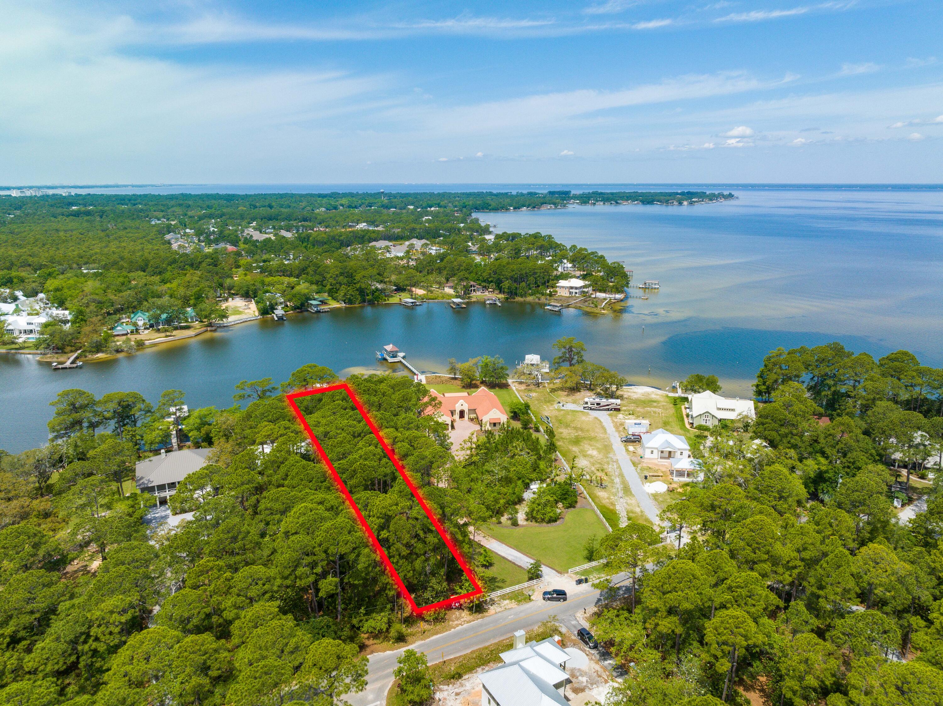 Under contract - accepting back ups. Introducing a breathtaking property located in the serene and picturesque Santa Rosa Beach, FL - a Deep Water Bayou front lot at 21 Hewett Point Road. This property offers an incredible 117 ft of water frontage and is situated right at the mouth of Hewett Bayou, providing you with direct access to Choctawatchee Bay and the Gulf of Mexico.Enjoy the beauty of nature and the tranquility of waterfront living as you relax and unwind on the newly constructed pier, complete with a dock and covered boat house that features a 10000 pound boat lift. Imagine watching spectacular sunsets from the comfort of your own backyard, surrounded by the peaceful sound of lapping water. The purchase of this lot comes with an added bonus, as it includes approved and stamped plans for a 3600 square foot home. This property is truly a rare gem, offering the best of waterfront living in one of the most coveted locations in Florida. Don't miss this opportunity to own a slice of paradise at 21 Hewett Point Road.