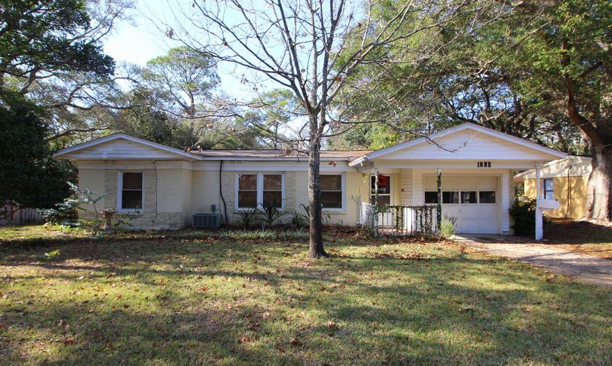 RARE FIND COME SEE THE ENDLESS POSSIBILITIES! Fantastic location across the street from the bay and situated in the much sought after Elliott Point neighborhood. Living area has hardwood flooring, built-in bookcase, and a mirrored accent wall. Spacious and open family room and dining area with built-in china cabinets and a gas fireplace for those cozy winter nights. Light and bright kitchen with a window over the sink, lots of cabinets and counter space, 5 burner gas stove with a double oven and a large breakfast bar area. Double doors lead into a large tiled Florida room that could easily be used as a master bedroom with a private bath. Three additional bedrooms, one of which has French doors that lead out to a private patio. Two additional full baths next to the three bedrooms.