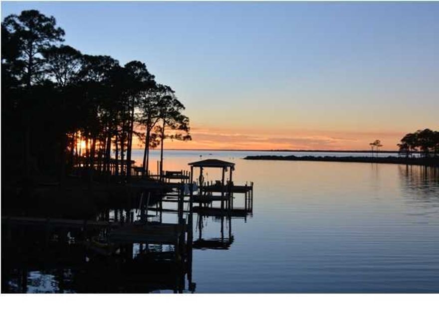 STUNNING, almost new, custom built waterfront home with gorgeous views of Grass Lake and the Choctawhatchee Bay. This home is LOADED with amenities and custom upgrades! Upon entering this lovely home you'll find yourself in a spacious open floor plan that is perfect for family gatherings and entertaining. There is Acacia engineered hardwood flooring, custom colonial door and window casings and crown molding throughout all living areas and bedrooms. The custom kitchen features cream glazed 42''cabinets, a large island with espresso cabinets, a vegetable sink and seating for 3. The kitchen also has granite countertops, large stainless apron sink, stainless appliances, a Kenmore Professional Series 6 burner gas range and even a pot filler! Too many extras to mention.