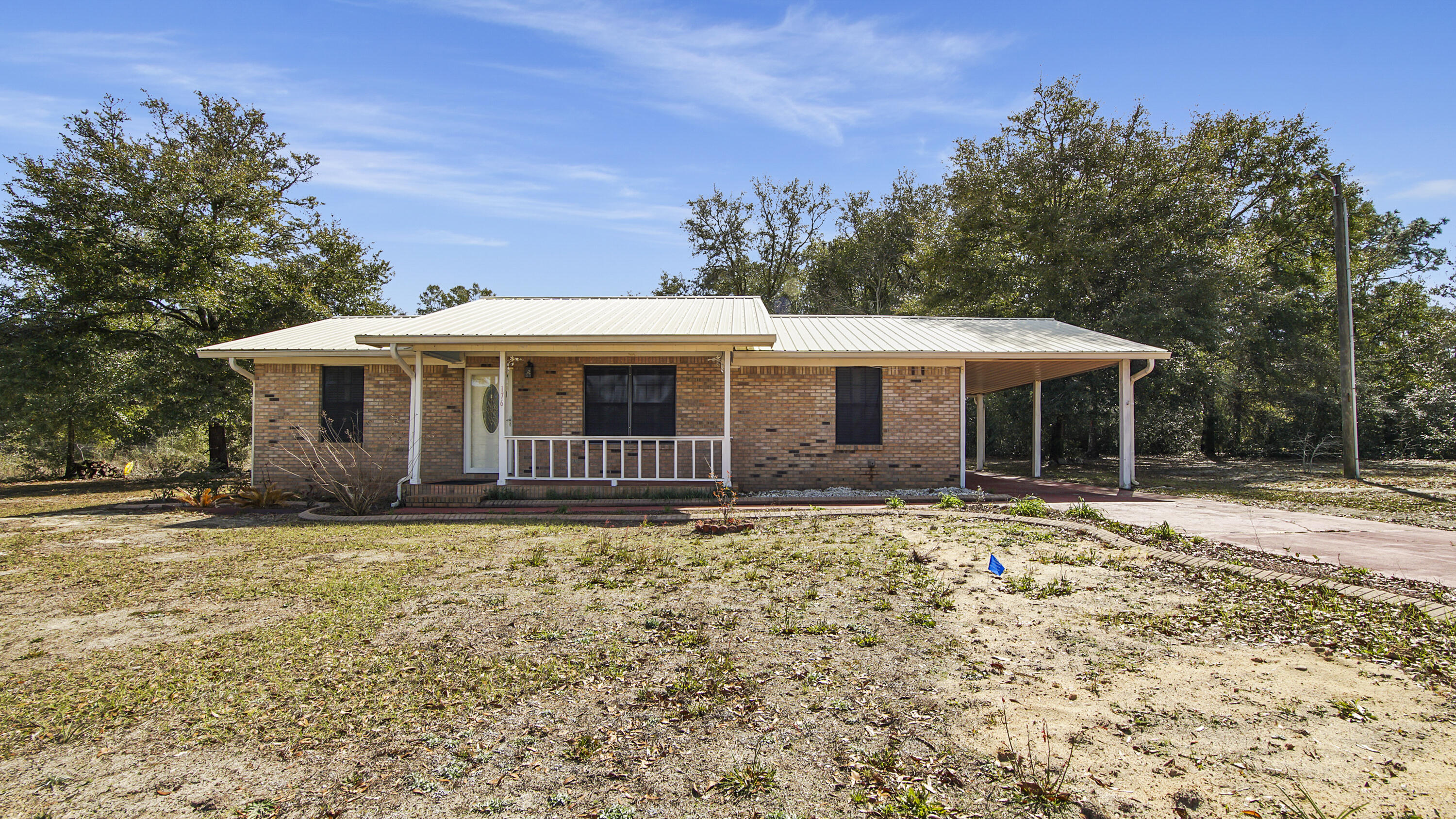 Discover this 3 BR 1.5 BA brick home nestled on just over an acre of land in the lovely DeFuniak Springs. Enjoy your morning coffee on the front porch or unwind in the peaceful surroundings.The home features a metal roof and vinyl flooring. Take advantage of the spacious carport, providing convenient parking and storage options. With no HOA, you have the freedom to make this space your own!This home is ideally located five minutes from downtown DeFuniak, near public boat ramps, and a short drive away from the beautiful beaches of South Walton. Don't miss out on this great buy!
