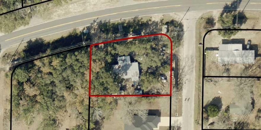 This corner lot on East Bay Blvd in Navarre, offers an opportunity to build your future home. The property currently has a non-livable, rundown mobile home and will require clearing. It is being sold as land only, with no improvements or clearing to be done by the seller. Situated across the street from the bay, it offers a slight peekaboo water view and is surrounded by well-kept homes. Bring your vision and builder!