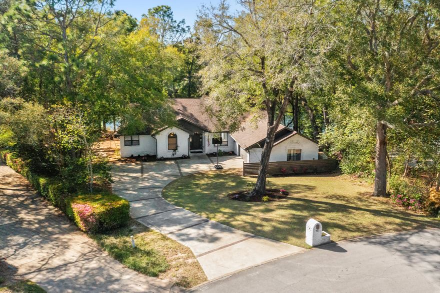 A ONE OF A KIND renovation! Surrounded by mature landscaping on the largest lake front lot in the neighborhood, this fully remodeled, four bedroom home is a show-stopper! With a timeless interior design, this home features an open concept with a split floor plan and direct lake views from nearly every room. Upon entry you a greeted with 17th century French stable doors highlighting a flex room commonly used for an in-home office space.  The large Foyer has a board and batten accent wall and an art deco sconce that opens to a formal dining room overlooking the lake. Perfect for entertaining, this space is centered around a stunning Venetian plaster fireplace, beverage bar, and additional cabinetry for storage.  A neutral, white Oak engineered hardwood runs throughout the living spaces. The heartbeat of the home is the kitchen! Centered in between the formal dining and indoor/outdoor living spaces, the kitchen is an easy flow in any direction with large windows that allow for natural lighting when you start your day. With floor to ceiling cabinetry, a Viking gas stove with custom range hood accented by a brass pot filler, 42" GE Monogram refrigerator, stainless steel appliances, quartzite countertops, and gorgeous hardware, everyone is staying for dinner!

Next you will enjoy a peaceful view from floor to ceiling windows in the living area. This room overlooks the lake and an expanded deck that wraps around the back of the home, making it easy indoor to outdoor living with glass sliding doors.

This property maintains a single story floor plan. However, bedroom two features an upstairs loft area perfect for additional heated and cooled storage or a game room. The secondary bathroom has custom vanity with Carrera marble floors, Quartz countertops, custom cabinetry with a pull out step stool, and a deep soaking tub with separate walk in shower. All bathrooms throughout the home have unique light fixtures and hardware.

Across the home is the Primary Suite with both deck access and lake views. The room has double walk-in closets with wood cabinetry shelving and storage and a large spa-like en-suite. The en-suite has a large walk-in shower with dual shower heads, Steam aroma, and a glass enclosure plus a soaking tub with his and her vanity areas.

No detail was left undone with this home renovation! The homes has a lawn pump sprinkler system, whole house generator, outlet for an electric vehicle in the garage, and spray foam insulation throughout. Please ask about options to purchase furnishings. This home is also listed as FOR SALE.