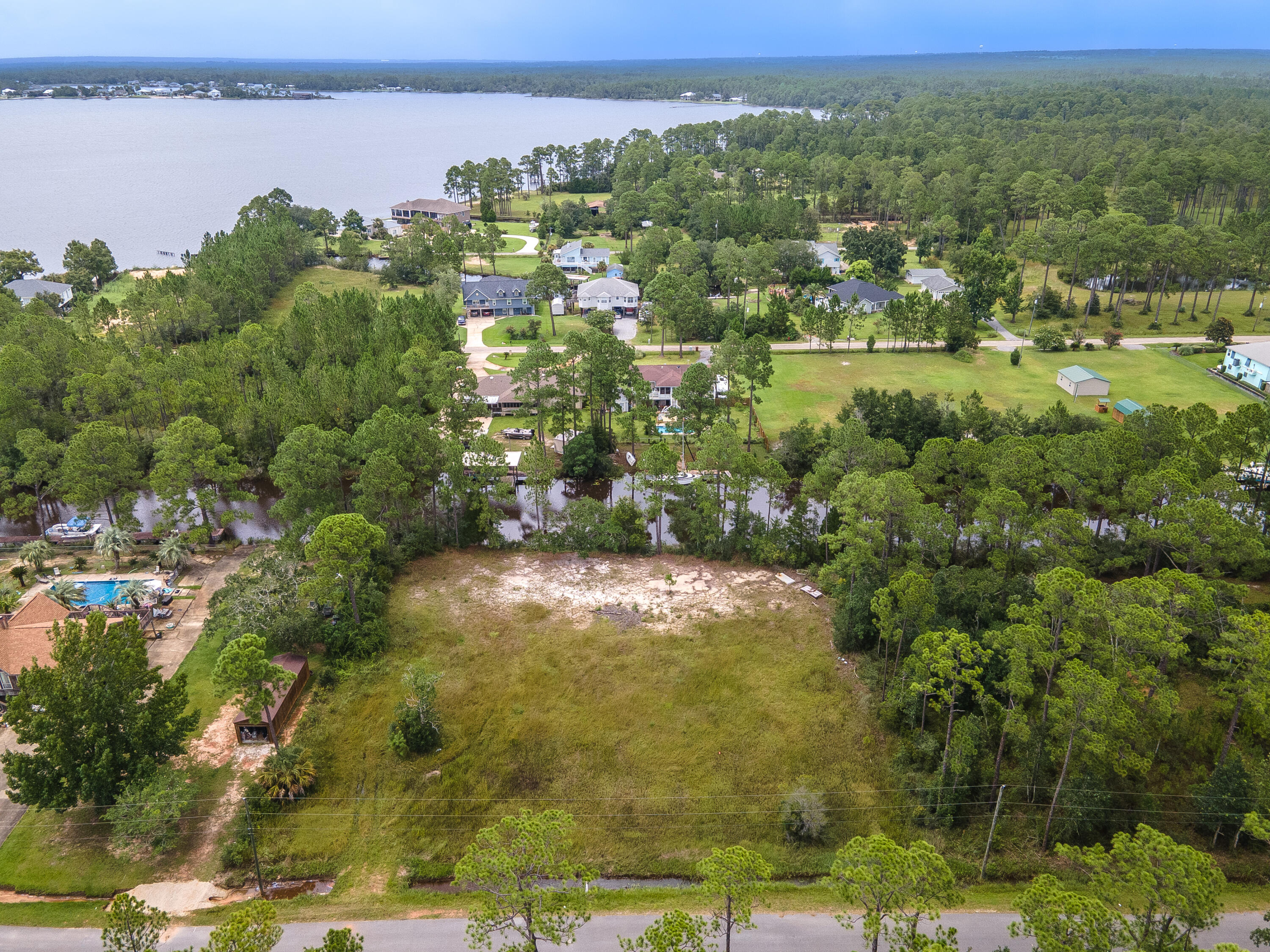 CLEARED, FLAT AND READY FOR YOUR NEW HOME! 200 ft. of water frontage! Deep water canal with access to the beautiful Blackwater Bay. Listing agent lives on this same canal, takes less than an hour to get to the pass depending on boat size and speed. There is not much deep water, water frontage to be found. You found what is left, so you better move quickly.