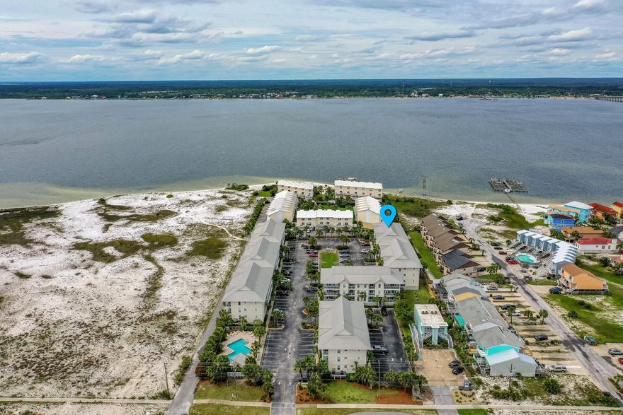 SPECTACULAR SUNSETS!  Views are breathtaking from this beautifully renovated 3 BED/ 2 BATH TOP FLOOR END UNIT overlooking the Santa Rosa Sound.From the moment you walk in you will be WOWED by the upscale furnishings and decor...This WOW FACTOR includes bead board ceilings, granite counter tops in the kitchen, full size laundry room, cultured marble counters in the bathroom, stainless steel appliances, shiplap walls, hardwood floors and tile, ceiling fans, recessed and custom lighting...Enjoy WATER VIEWS from every room except one. Located between the Gulf and the Sound, the beach access is a short stroll.Gulf Island offers a community pool, showers, grilling and restrooms. Fully Furnished and would make a perfect short term rental or primary home.