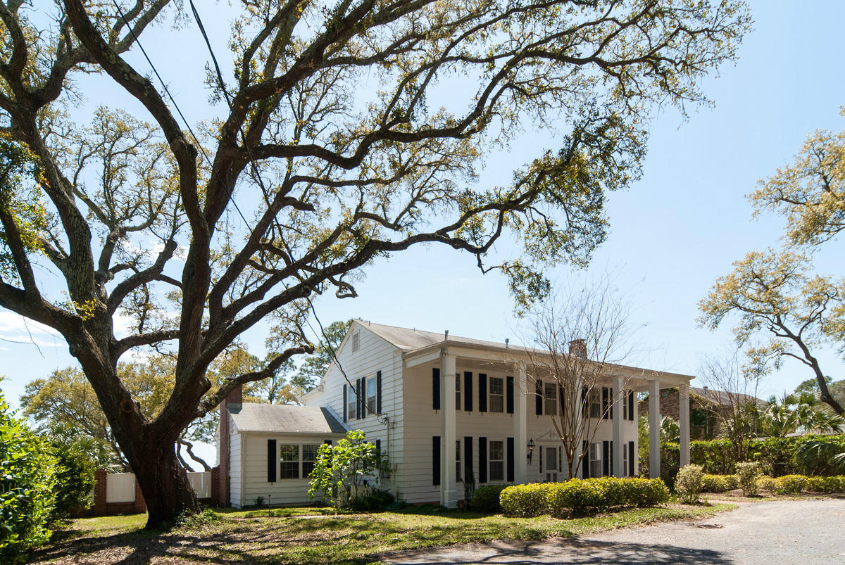 For generations this gracious four bedroom Sound Estate Home sitting on 106 feet of water was enjoyed by the Morrison family as their homestead.The beautiful gated grounds include a swimming pool, spacious dock, covered boat slip with lift, and a separate detached building. This special waterfront is offered for purchase for the first time in decades. Upon arrival Southern charm and deep South comes to mind. Nine paned windows framed by black painted shutters are viewed between six tall stately columns creating a striking facade. The owners describe the neighborhood as quiet, friendly and well established.The Central Hallway and Staircase are reminiscent of an old Plantation home providing access to the formal Living Room, the Screened Porch, Kitchen and Separate Dining Room.