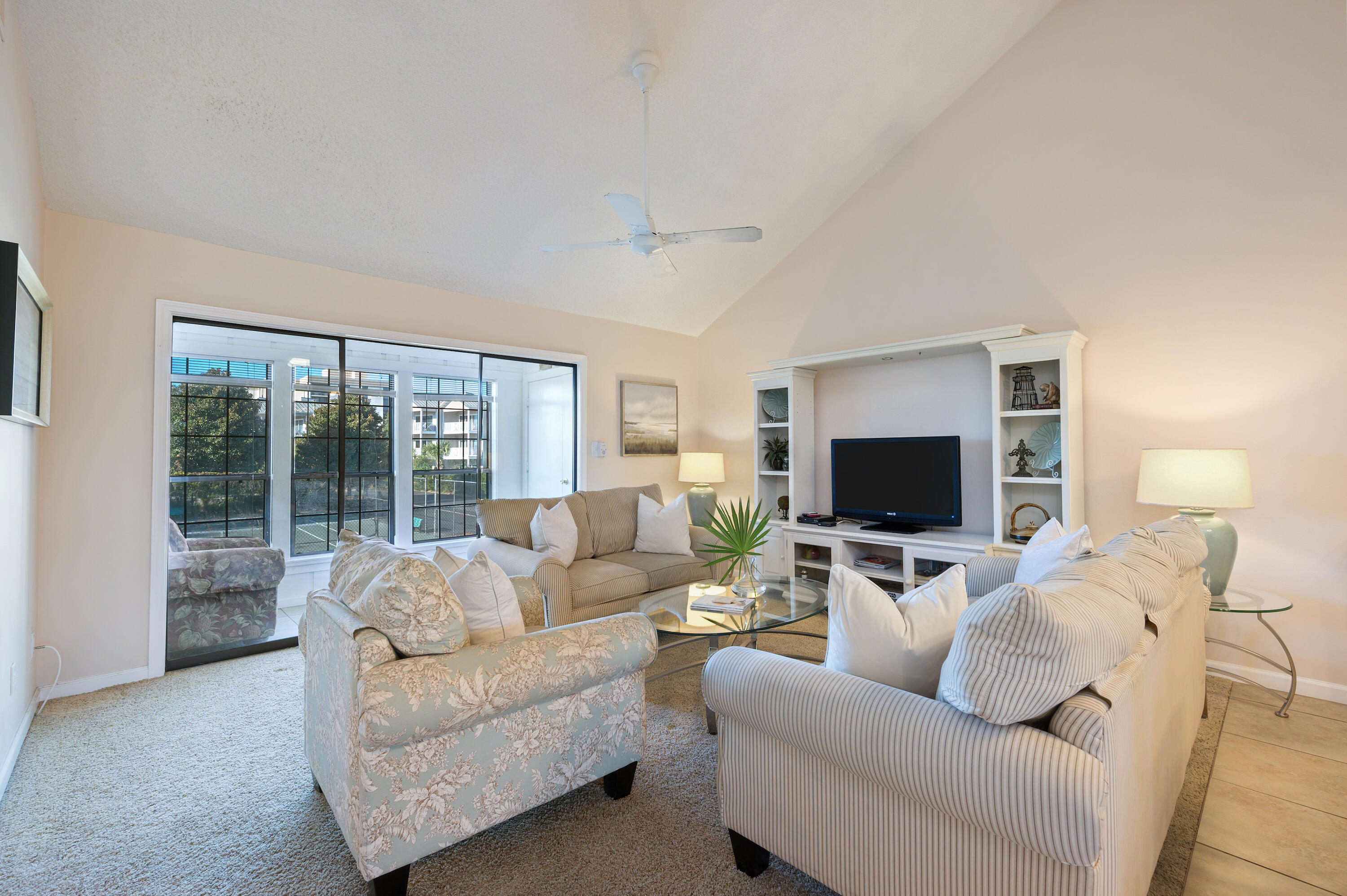 Top floor bright and airy 2 bedroom 2 bath fully furnished condo with vaulted ceilings and lots of windows to let in the sunlight. Enjoy the extra sunroom that was created by enclosing the balcony,some gulf views,the nicely updated kitchen with wood cabinets and granite counters,large bedrooms,full size washer & dryer, assigned parking in front and a perfect location just steps to the heated community pool and tennis courts. Located in the popular Chateau La Mer which boasts over 200 feet of private beach with gated access directly across the street and low HOA fees. 4 restaurants are within 1/2 mile including the beachfront Captain Dave's Restaurant.Whether a primary or secondary home,or lucrative rental investment,this low key community is just what you need to enjoy life at the beach!