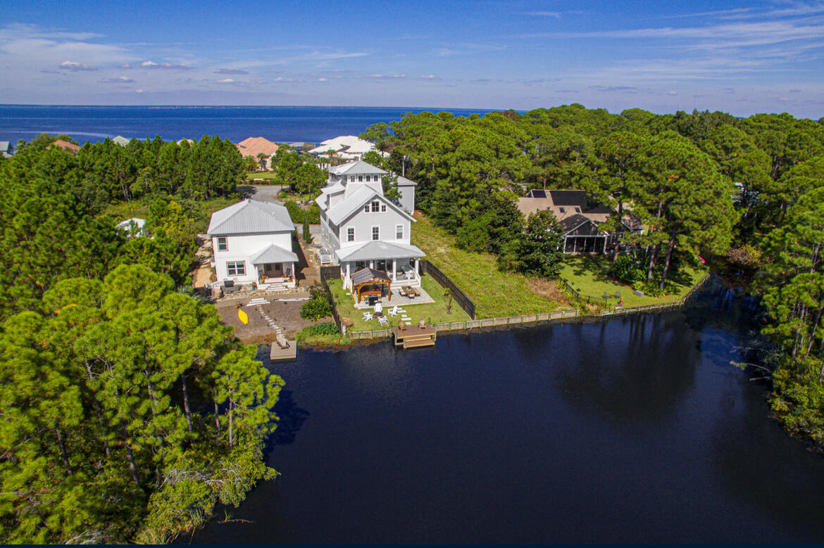 NO HOA + WATERFRONT + 10% Purchase Option! Introducing a lavishing WATERFRONT masterpiece with access to Choctawhatchee Bay, perfect for full-time luxury living or a short-term rental. Breathtaking views of the lake and bay grace every bedroom, 3 offices + the 360-degree tower offering unparalleled panoramic vistas. Designed to impress, this custom-built home boasts travertine flooring, a marble master bath, accent walls, and grand beams. The gourmet kitchen shines with SS appliances, quartz countertops, and an oversized island. Revel in the indulgence of the expansive back porch with fire pit, private dock, and Chicago-style brick wall. Boasting 4-bedroom, 5 bath + 3 offices, this Florida cottage-inspired home exudes elegance with its hand-crafted wooden ceilings + custom design Experience the pinnacle of lakeside luxury in this stunning custom-built home, where every room offers sweeping lake and bay views At the crown of the home, a remarkable 360-degree tower reveals breathtaking panoramas of the entire landscape.  Step outside to a beautifully crafted wooden ceiling on the expansive back porch, complete with a cozy fire pit, perfect for gatherings. Indulge in the spacious his-and-hers closets located in the master and high-end custom appliances this residence truly offers every amenity a family could desire for exceptional living.
Enjoy nearby parks, playgrounds, and public bay access all with no HOA, offering an exquisite blend of privacy and exclusivity.
Your short term rental, home away from home...or you waterfront dream home awaits.