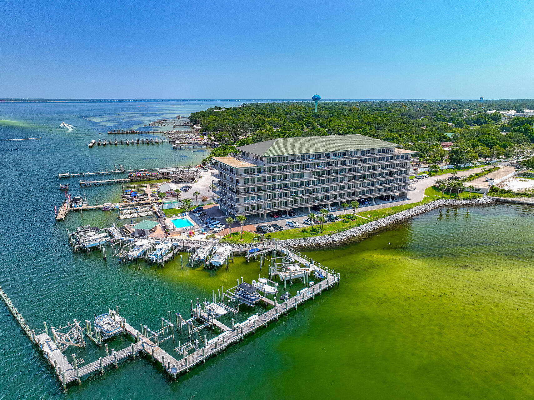 Luxury, fully furnished, waterfront condominium located in the desirable Sides Moreno Point West overlooking the Choctawhatchee Bay, Crab Island, the East Pass and Views of the Gulf of Mexico! This gated community offers western sunsets, views of dolphins playing, fishing, Destin Fireworks, resort style amenities and so much more! The condo is a 3 bedroom 3 bath home with 2196 sq ft! This home features a large private balcony overlooking the Bay and with views of the Gulf of Mexico. Relax on your balcony and watch sunsets, dolphins, and boats cruising in the Bay. The kitchen is large and perfect for entertaining! There are custom cabinetry with exquisite molding and crown, black stainless appliances, granite countertops with backsplash, undermount sink with brushed nickel hardware, and trayed ceilings with crown! In addition there is a peninsula that seats 4 and a pantry. This kitchen has a double wall oven, a built in microwave, and a side by side refrigerator with icemaker. The condo features an open floor plan with the kitchen opening to the dining room and living room. The dining area has a newer chandelier! The living room is spacious and all areas feature crown molding. There are gorgeous water views from the kitchen, dining, living room, and primary bedroom through the glass doors! The primary bedroom is very spacious and has views of the Bay, East Pass, and Destin Bridge. The ensuite bathroom has two single vanities, a walk in shower and cultured marble soaking tub! There are two additional bedrooms and two full bathrooms. The windows in the guest bedrooms have plantation shutters. Each room features plush carpet, ceiling fans, and large closets with shelving. This condo comes with a designated, covered parking spot. Sides Moreno West is located a short distance to HarborWalk Village, Destin Harbor, shopping, restaurants, and the white sandy beaches of the Gulf of Mexico. This home can be a primary, second home, or investment property. A boat slip may be rented, if available. The Sides Moreno Condo Association maintains the property in excellent condition and is very well managed! This condo has it all, Western Sunsets, Unobstructed views and panoramic views, large open balconies, close proximity to excellent entertainment and restaurants. Buyer to verify all dimensions and information.