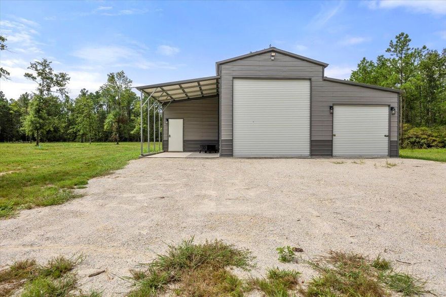 JUST REDUCED!! Escape to tranquility with this stunning 10-acre property, an ideal sanctuary for those seeking a safe haven away from the water! Nestled in the heart of nature, this UNRESTRICTED land offers endless possibilities and ultimate privacy. A brand new 1,600 sqft steel structure provides ample storage & workspace. Included is a charming 300 sq. ft. area w/full bath. Approximately 4-5 of the 10 acres are cleared, offering plenty of space to build your dream home. The property comes equipped with a septic system, private well, electrical service, & 2 RV hookups.  Property is partially fenced.  This is an ideal location to safeguard your belongings and loved ones during hurricane season. With no restrictions, you have lots of options! This property is a gem!!