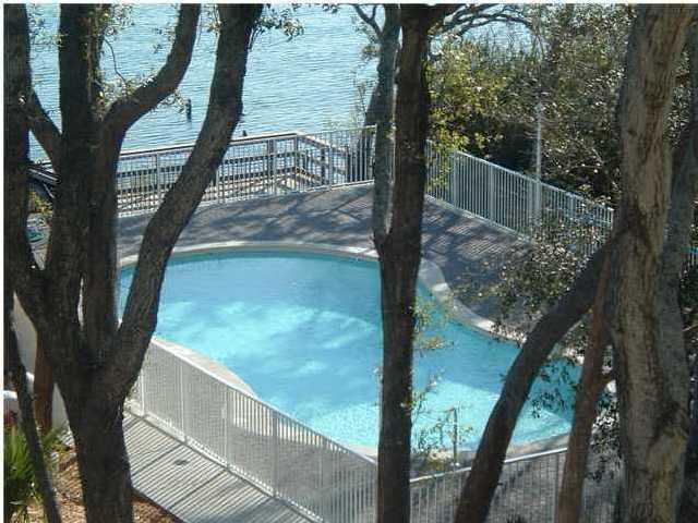 Beautiful condo on the first floor with a great downtown location. 3 bedrooms, 3 bathrooms. Gated entry.  Unit overlooks the Landing.  Complex is waterfront. All tile except carpet in bedrooms.  Stainless appliances, granite countertops with breakfast bar.  Boat slip- may be purchased for an additional fee.  Pool in complex. Small pet under 25 pounds are allowed for owners.  Short term rentals- must stay at least 31 days. Seller will consider owner financing with 5.5% ( $32,725.00 ) down payment and 5.5% interest rate on balance. Marina membership and extra marina storage is also available for purchase.