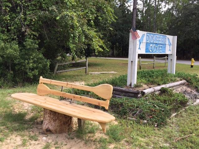 NEW PRICE! One acre wooded lot available in the quiet subdivision of Dolphin Cove. Great place to build your dream home and just a short drive from Bluewater Bay, Niceville, and the sandy white beaches of Destin. Community water available. Great view of the Choctawhatchee Bay across the street.