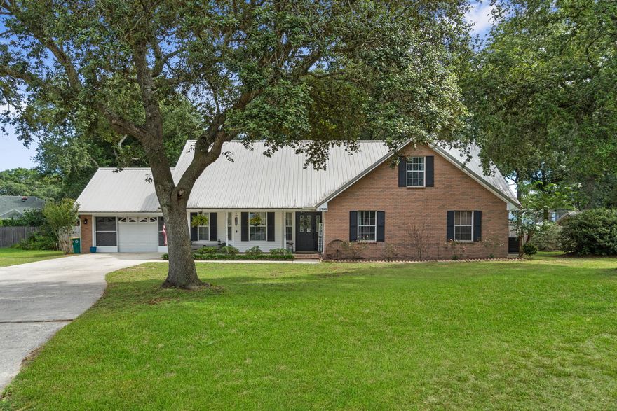 Welcome home to this beautifully updated 4 bedroom/3 bath (plus a flex room) south Crestview property at the very end of a cul-de-sac with an additional detached garage/workshop on almost a half acre lot!  This absolutely charming home with a long lasting metal roof features a fantastic floor plan with an in-law suite upstairs with its own living room space open to the bedroom, along with an updated bathroom and a huge closet!  Pull up into the oversized long driveway and you'll immediately feel welcomed in by the inviting covered front porch and the yard accented by a beautiful oak tree. Inside you'll find a home full of updates and character, no cookie cutter house here! Luxury vinyl plank flooring extends throughout all the common areas and you'll love the soaring vaulted ceiling in the spacious living room accented by a gas fireplace. Upon entering there is a flex room to the left (currently used as a play room) and 3 of the 4 bedrooms (including the master bedroom) are located on the first floor. The kitchen has a large eat-in space with plenty of room for your dining room table, and the kitchen is well appointed with granite countertops and a gas range! You'll love the updated bathrooms, all three featuring new lights, mirrors, fixtures as well as tile and shiplap accents, and all the bedrooms feature newer carpet. The two car garage includes sliding screens and the huge backyard is entirely fenced in with a privacy fence with a double gate on the right side and a detached garage/workshop in the backyard with power! You do not want to miss this charming and unique home!