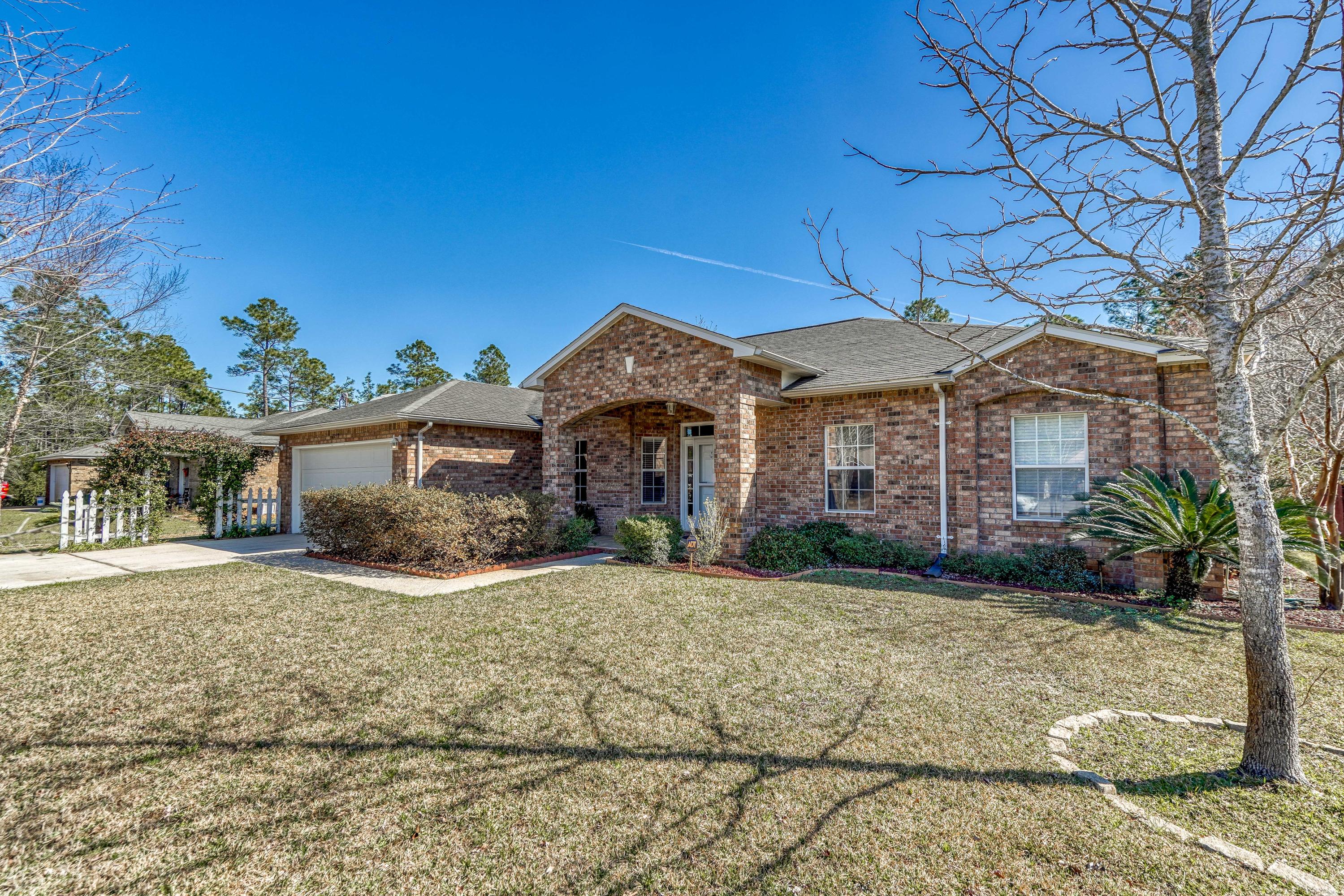 Beautiful and Private All Brick 4 Bed/2 Bath Home Tucked Away on over 1/2 Acre Lot on Private Road with No Through Traffic and great Location in Holley by the Sea! This Spacious 2272 Sq Foot Home with Curb Appeal has Tile and Wood Flooring throughout, a Formal Dining Area, Breakfast Nook, and Office in addition to the Four Bedrooms. The Kitchen boasts Granite Counters and Stainless Appliances with Plenty of Cabinetry, Storage and a Pantry. The Master Bedroom has Private Access to the Patio along with a large Master Bathroom. The rear of the home features a Large Screened in Patio with a Grand Back Yard Equipped with Privacy Fence and Bordered by Woodlands for a Serene and Peaceful view. Ownership of this home includes membership to Holley By the Sea's nearly 50 ACRE recreational center...