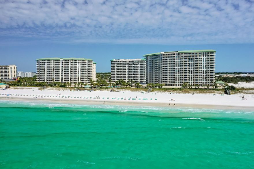 This one-of-a-kind 2600 sq. ft Twin Master Lanai unit is a perfect family beach retreat. Boasting 11 ft. ceilings, large living area, designer furniture, upgraded baths, designer kitchen, and two gulf front master suits and a bonus room which can be used as an office, den or small bedroom. Add that to a huge outdoor area that leads right to the pools and beach and you are ''toes in the sand''. Floor to ceiling glass add a ton of natural light, with a water view from every room. The kitchen finishes include granite counter tops with a built-in dining area, Viking range, Sub Zero refrigerator, Bausch dishwasher and loads of custom cabinets w/built in wine rack. Both master baths boasts custom cabinets and tile work, stone counter tops, twin sinks and Mor