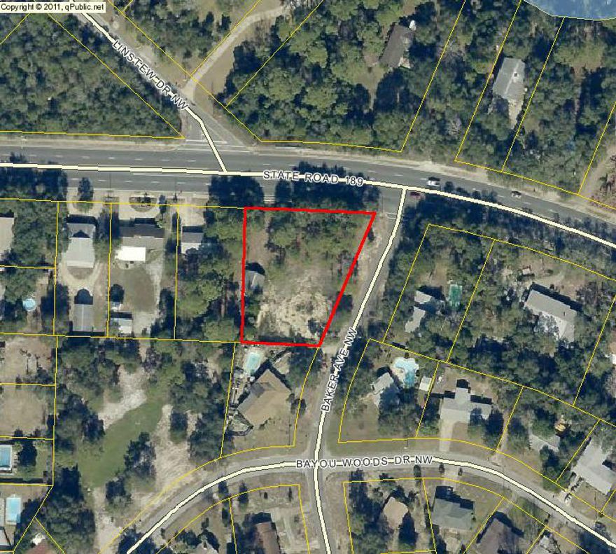 Almost 3/4 of an acre building lot with storage building that needs work. Corner lot convenient to all the businesses on Beal. Established neighborhood