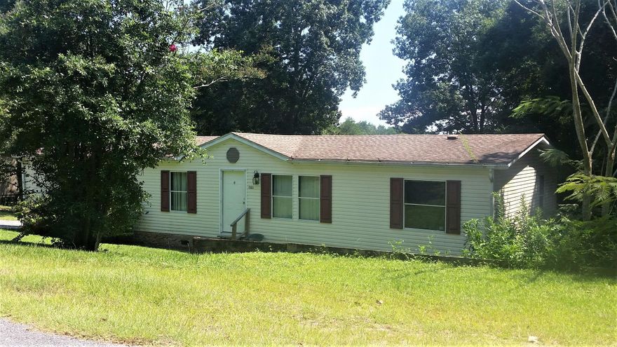 Waterfront manufactured home on Lake Juniper, a 600 acre fishing lake with some of the top bass fishing around! This home was special ordered in 1995 it is a roomy 28x60' is nicely designed with the family room, and breakfast room and master bedroom having water view. The kitchen has a built in china cabinet at the end of the low-bar breakfast bar. Kitchen has an enormous amount of cabinets and deep double sinks, and comes with electric stove, and dishwasher. Kitchen and family room combo measure appx. 13x24'. The formal living room and dining measure appx. 12x25'. Formal dining room and living room, plus a Family room that wood burning fireplace (never been used), with brand new sliding doors with a water view. Seller has just had a lot of work done on the home...