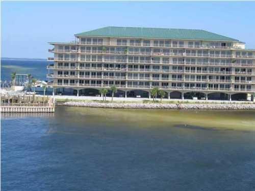 40 Foot Deep Water Boat Slip #3 Included In Price! Enjoy the views of Crab Island from this Upscale, Updated Condo.Upgrades include granite kitchen with stainless appliances. 10' ceilings, upgraded lighting & ceiling fans. High efficiency washer & dryer. Master bath upgrades include dual vanities with granite, glass shower enclosure, whirlpool tub. Rental income of $3150/month/$38k annual. Tenant pays utilities. Continue rental income or enjoy as your personal residence. From the over sized balcony enjoy the fireworks display, dolphins & boating. Views of Crab Island from balcony. Walk to Harbor Walk Village for dining, entertainment & shopping or take your boat from your dedicated boat slip. Gated property includes fitness room, pool, barbecue grills, gazebo. Furnishings negotiable.