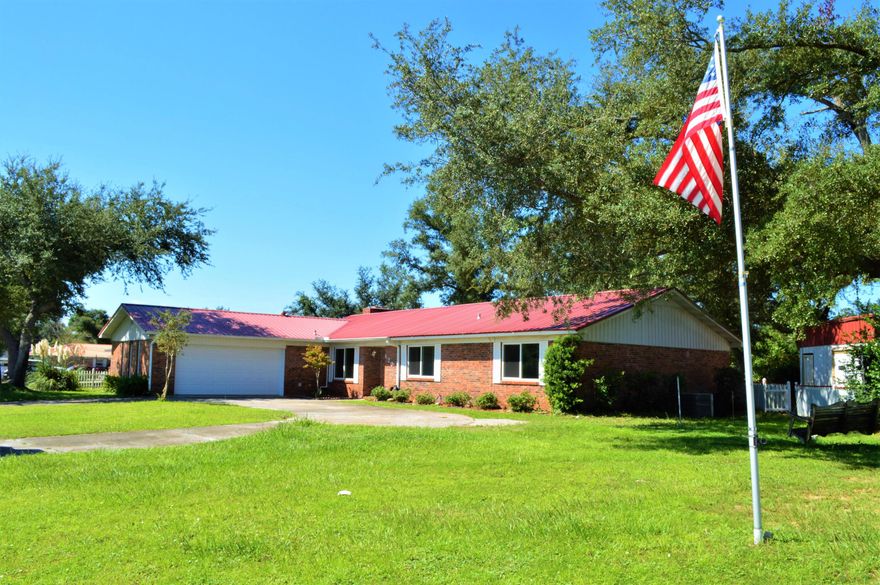 Looking for a home with plenty of room inside and out? This 4BR/2BA home is close to Tyndall AFB, schools, shopping and more and is more than adequate for a growing family! Nestled on a .77 acre lot, features include a metal roof, two car garage, detached workshop/garage with attached pole barn, circular driveway, and a privacy fenced backyard. The sellers replaced the windows and doors including a new slider to the screened porch, and a new garage door in 2019. The floor plan includes a living room, den, formal dining room, and large kitchen with island. Built-ins, fireplace, walk-in closets, some wood flooring, and new carpet in two bedrooms are just a few highlights to this fantastic home! All info approx & Buyers must verify if important.